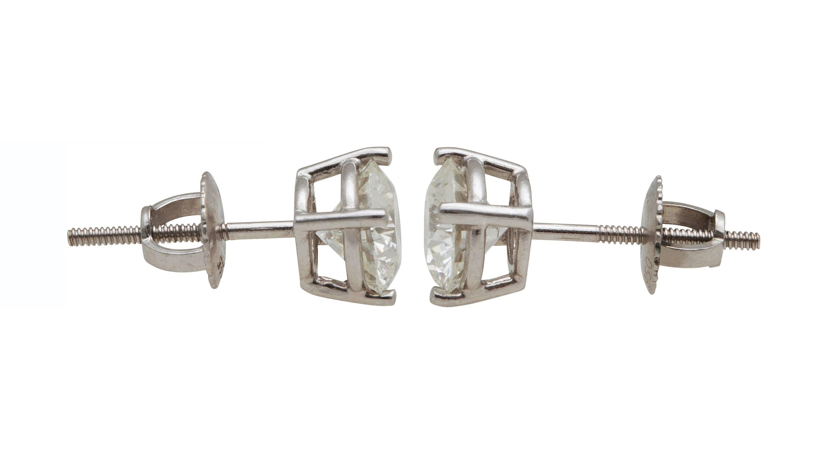 Tiffany & Co. Diamond Stud Earrings in Platinum, with 2.04ct. Total Diamond Weight. Classic four prong mountings with screw on backs, containing 2 Brilliant Cut Diamonds  1.02ct H VS1 & 1,02ct H VS2, Both diamonds are accompanied by Tiffany