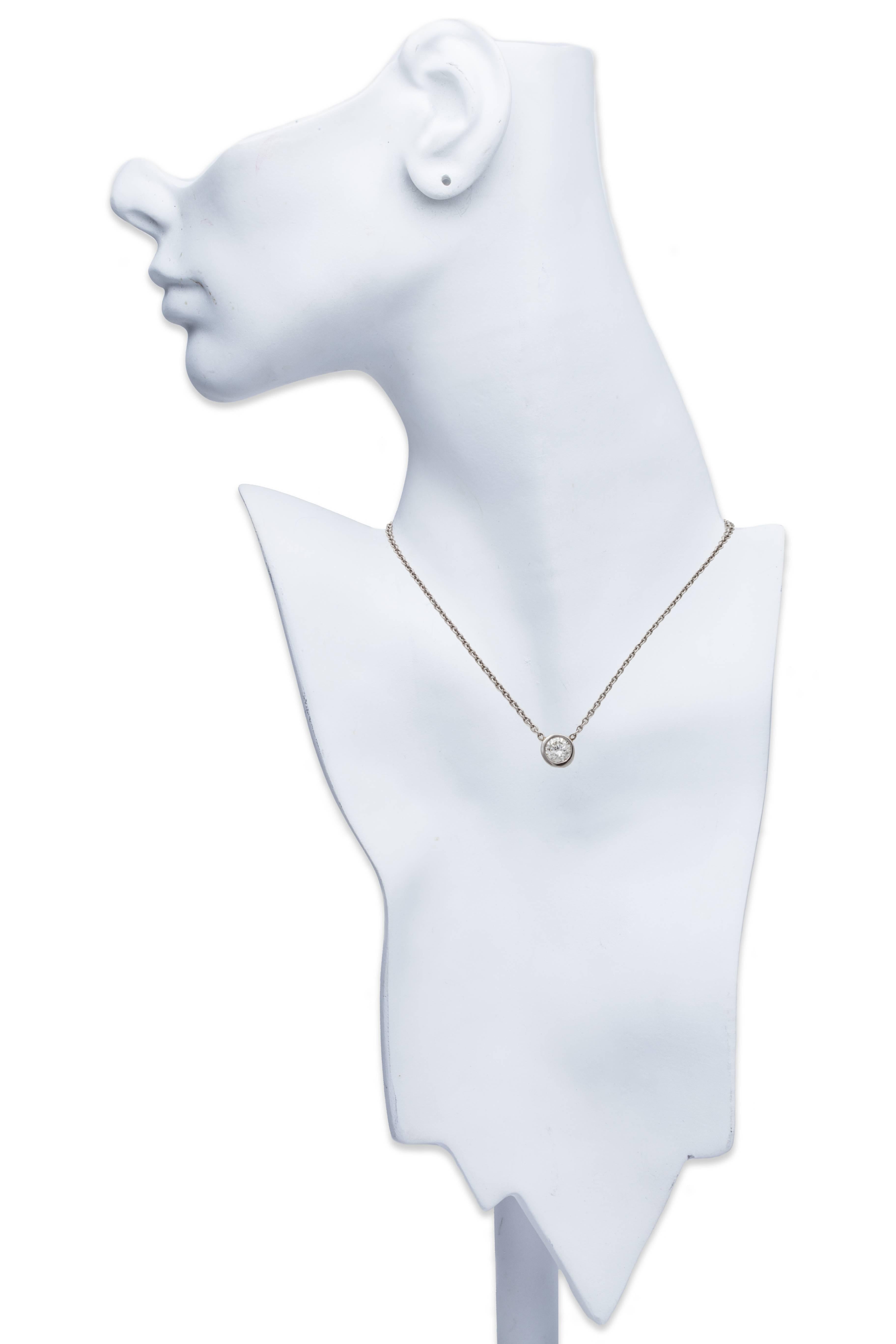 Solitaire Diamond Pendant Necklace in Platinum. Single bezel mounted brilliant cut diamond suspended from a platinum chain. Total Diamond Weight 0.75ct., Chain Length 15