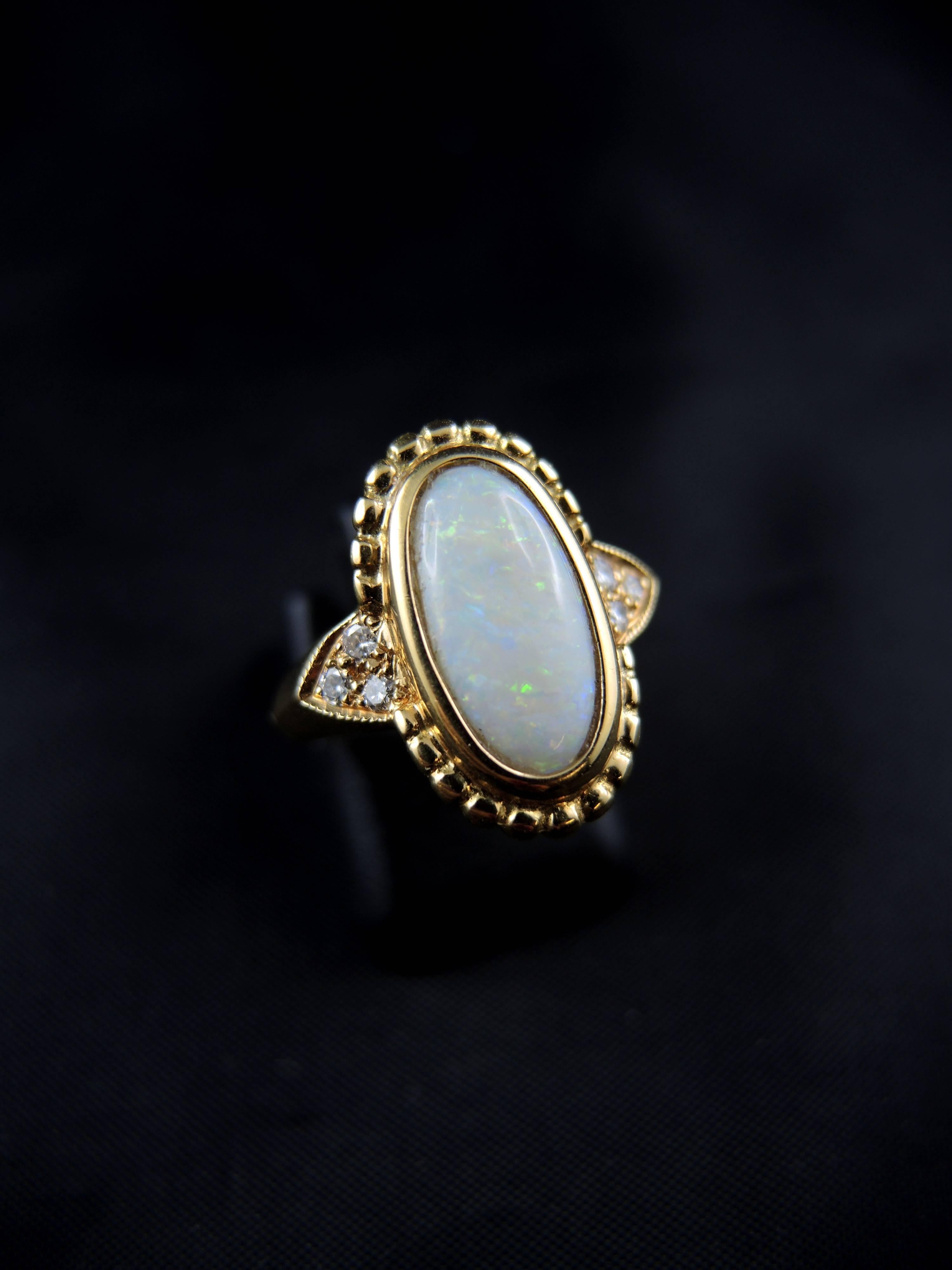 
18kt yellow gold ring (quality mark: head of eagle) with a oval cabochon of opal, weight around 1,10 Ct (certainly from Australia), and modern brillint cut diamonds, which total weight is estimated around 0,10 ct.

French modern work.

Weight: