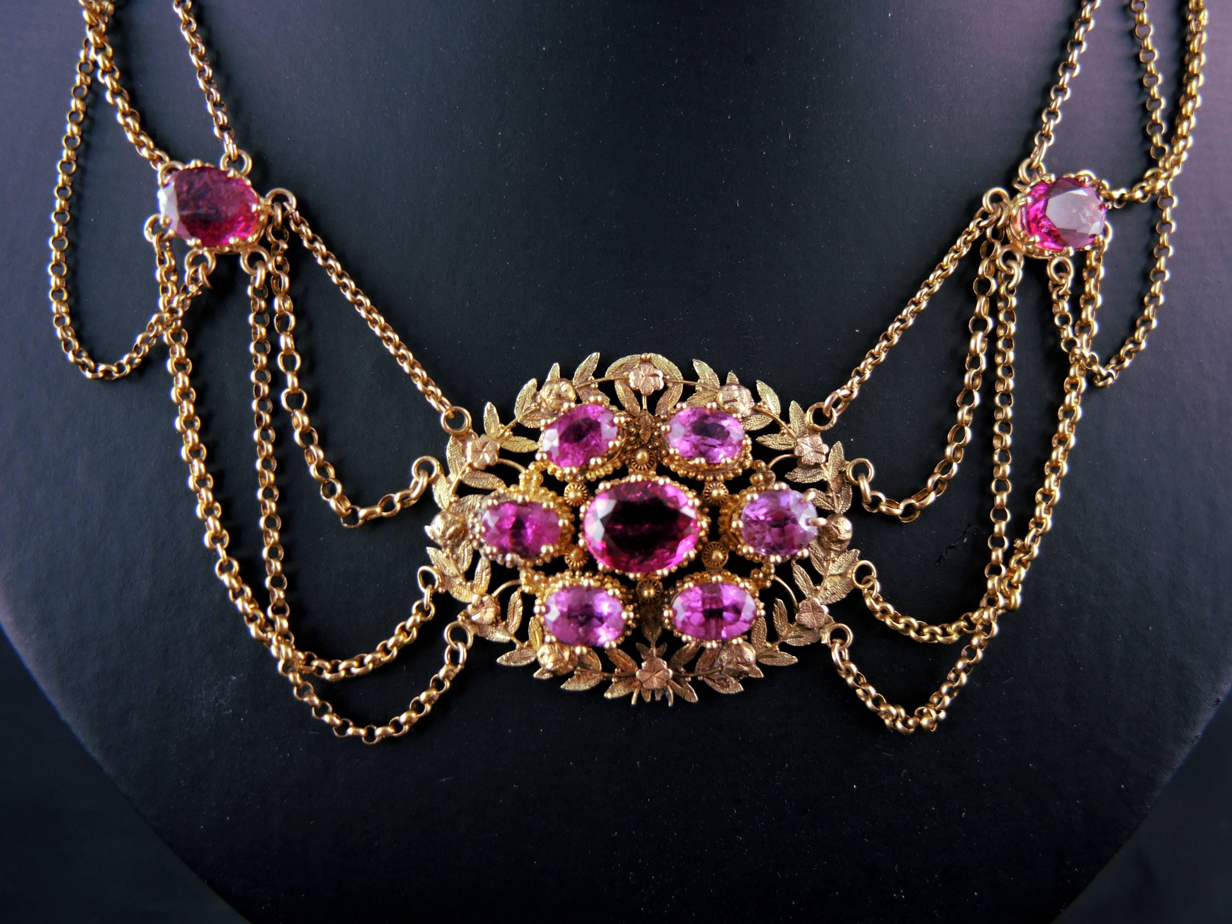 An extraordinary hand crafted Collier d’Esclavage made in 18kt and 14kt gold (quality marks: owl and scallop). Multi strands with links are caught by a central chiselled plaque set with beautiful vivid pink tourmalines

Work from the early 19th