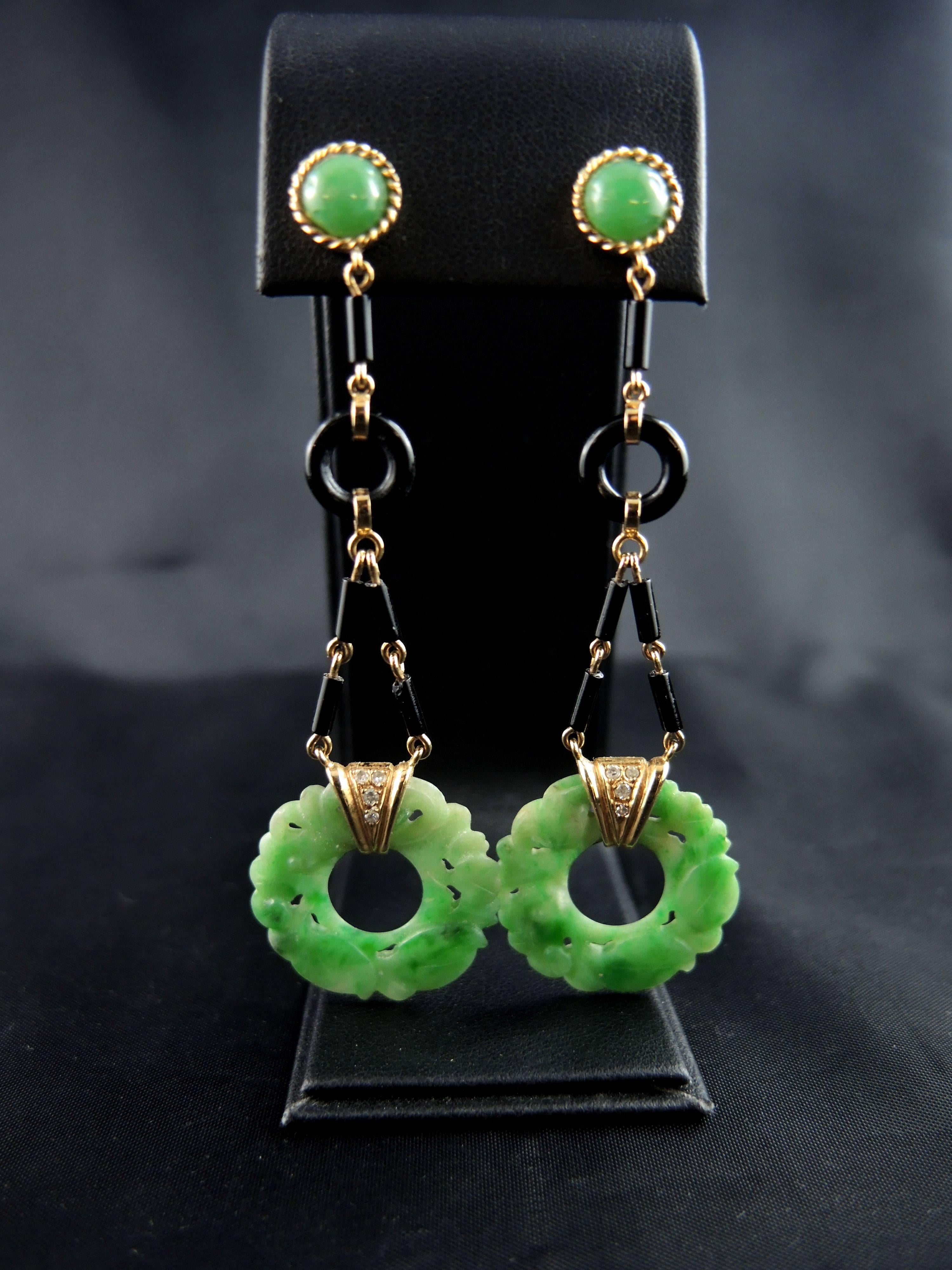 18kt gold earrings (quality mark: head of eagle) set with delicatly carved jadeite jade disks, onyx, and single cut diamonds.

French work from the 70ies with an asian style.