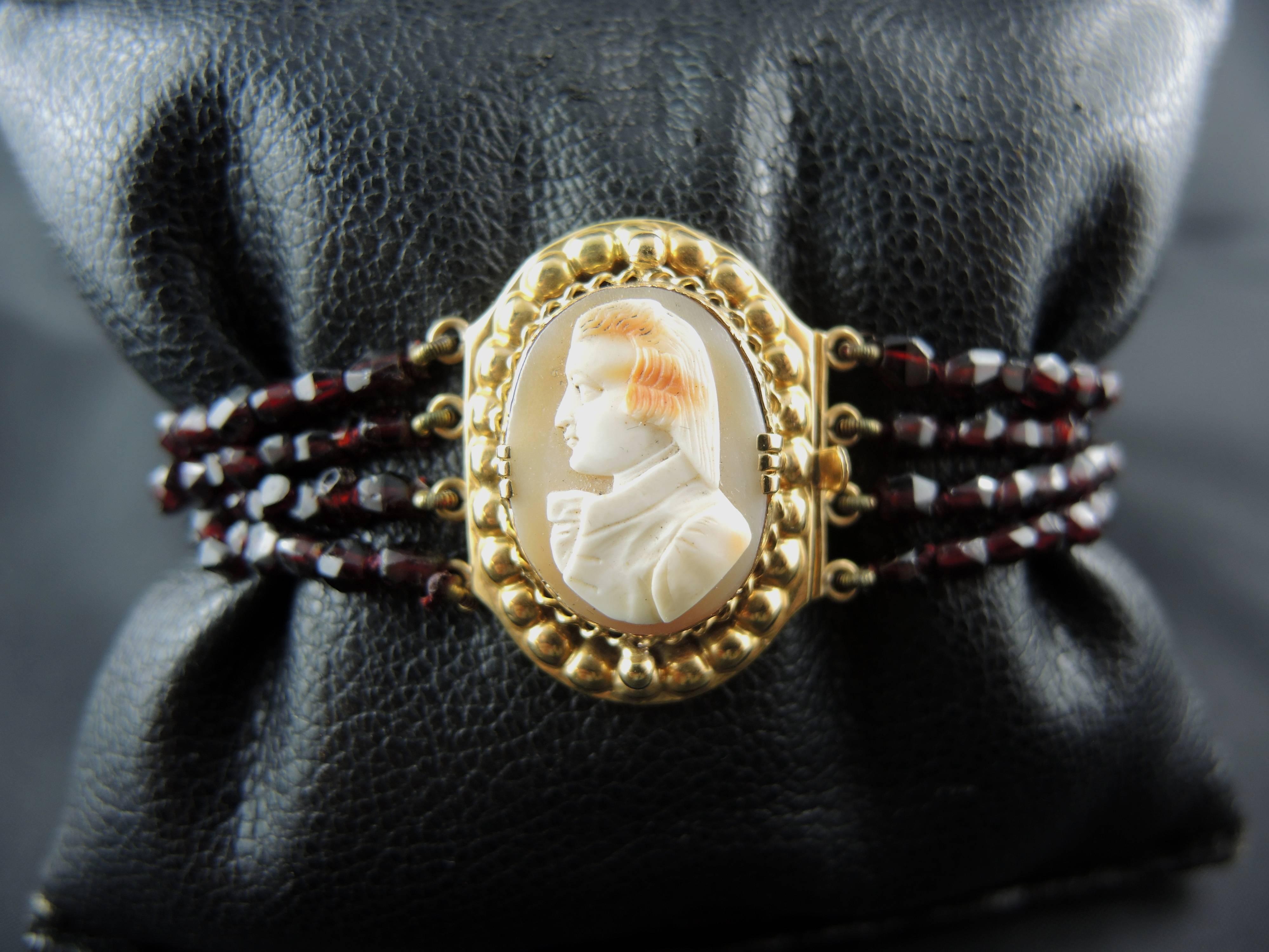 18kt yellow gold bracelet (quality mark: eagle's head) set with four garnets strands, and a shell cameo showing a man.

French work from the 19th Century.

Weight: 35,90 g
Length: 18,00 cm

State : very little scratches on the gold parts, visible on