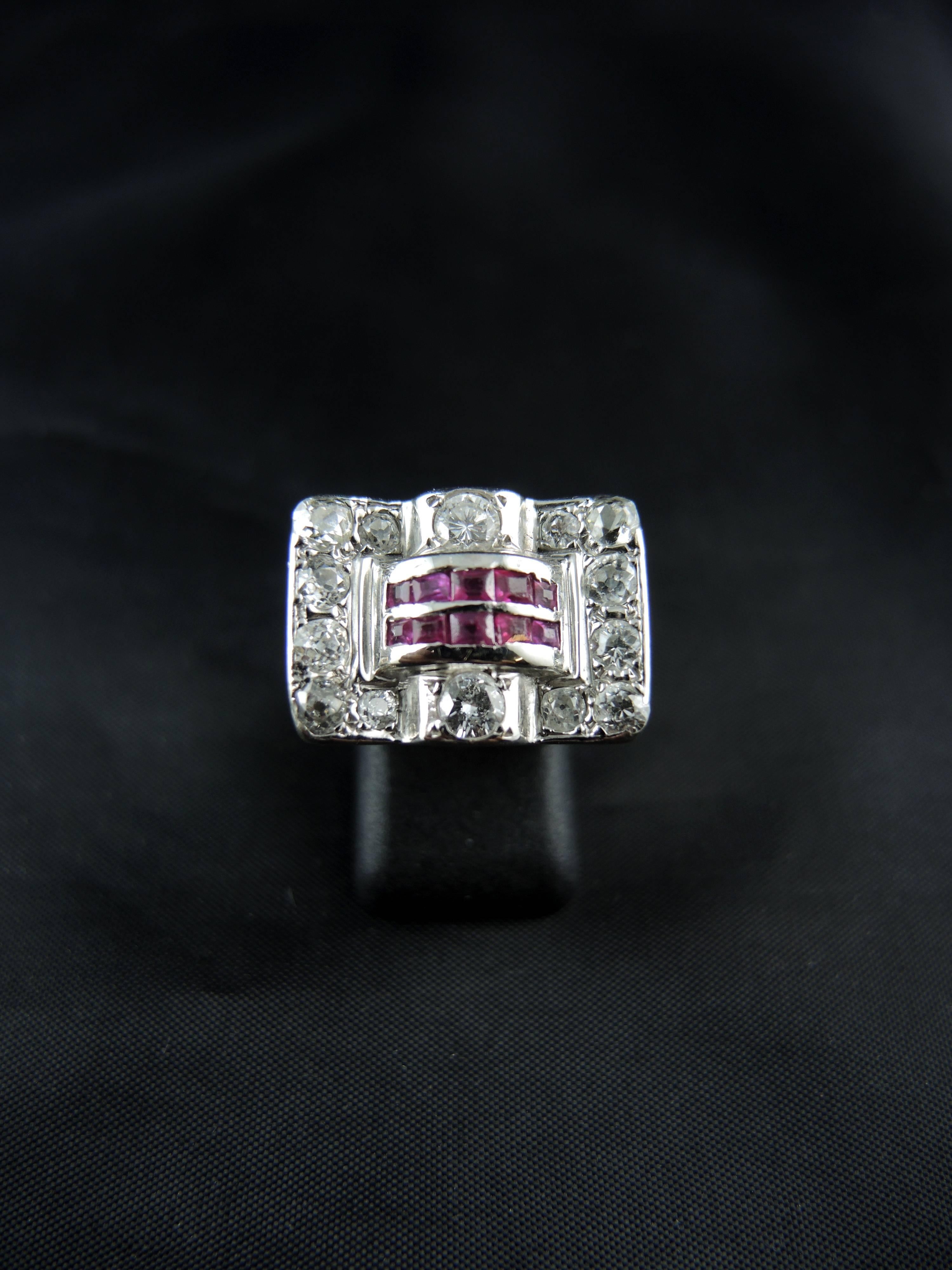 Expetional 18kt white gold Tank ring (quality mark: head of eagle) set with a mix of modern brillant cut and old cut diamonds (total weight estimated around 2,00 Cts), and synthetic rubies.

French work from the 40ies.

Weight: 11,60 g
Ring size: 48