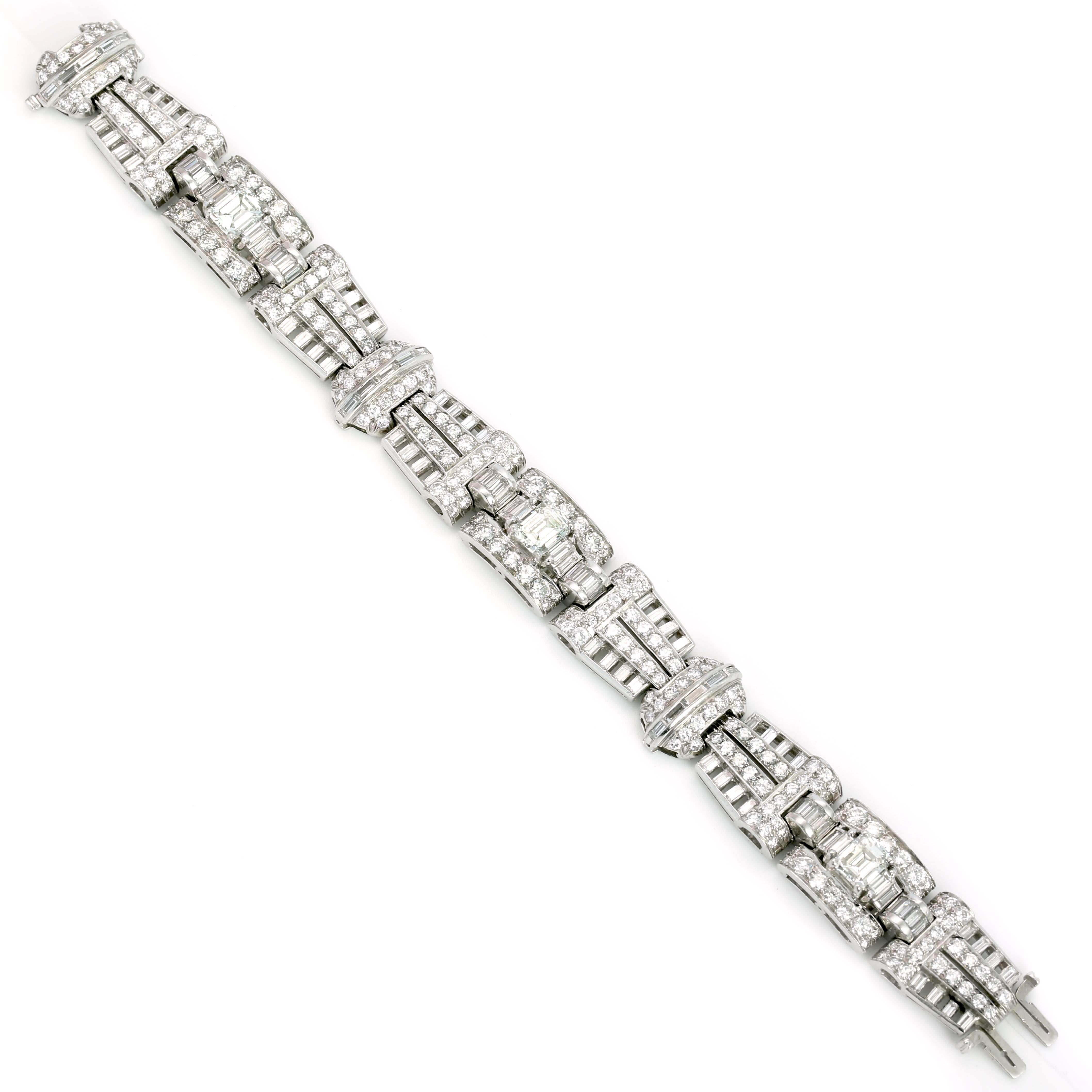 This Absolutely Stunning Deco Bracelet has 3 Emerald Cut Diamonds Weighing 4.20 Carats and 21.00 Carats of Diamonds on the Platinum Mounting.