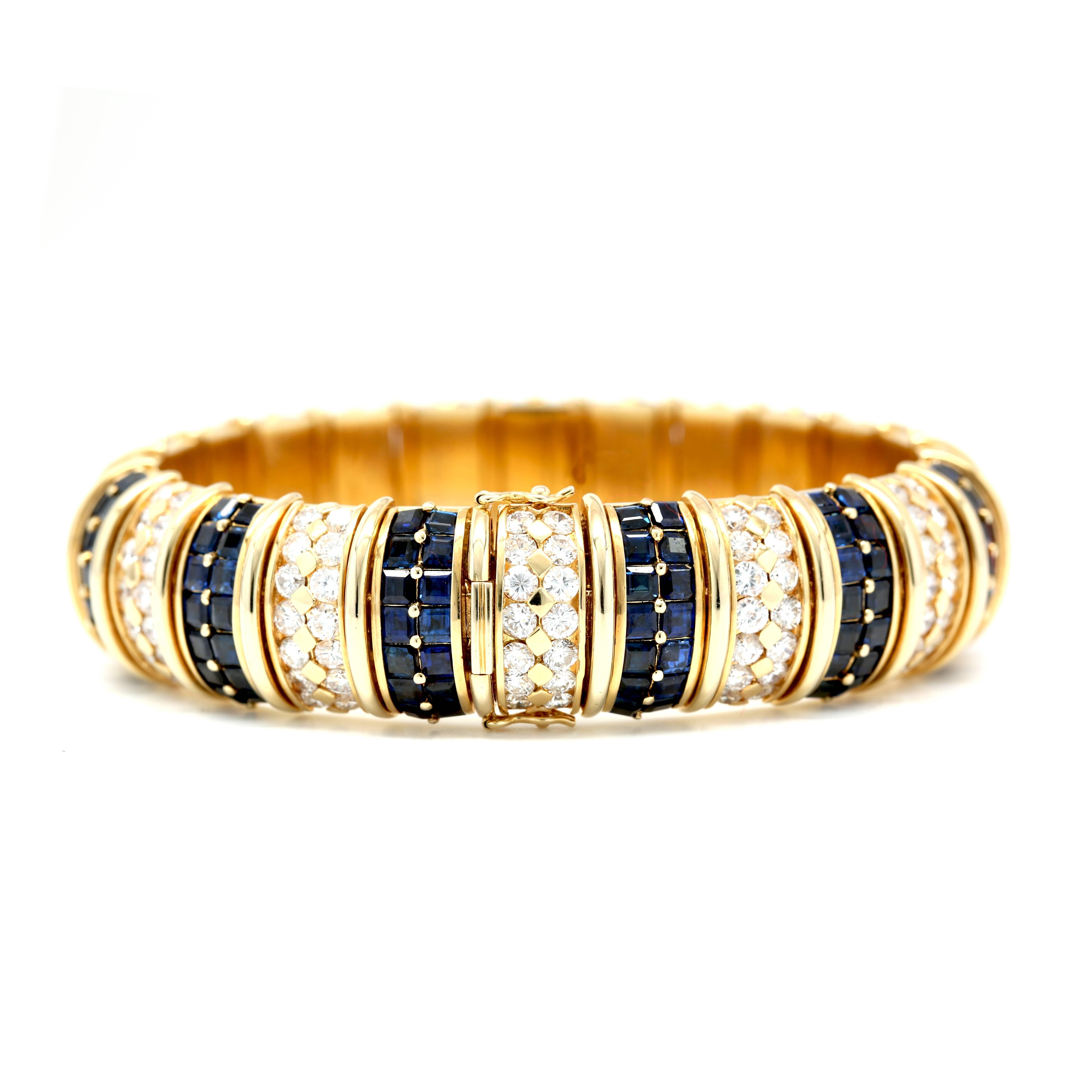 This Bangle features 168 Diamonds E-F/VVS-VS weighing 10.00 Cts and 
168 Sapphires weighing 15.00 Cts.
18k  Yellow Gold Bracelet
Metal Weight: 91.90 gm.