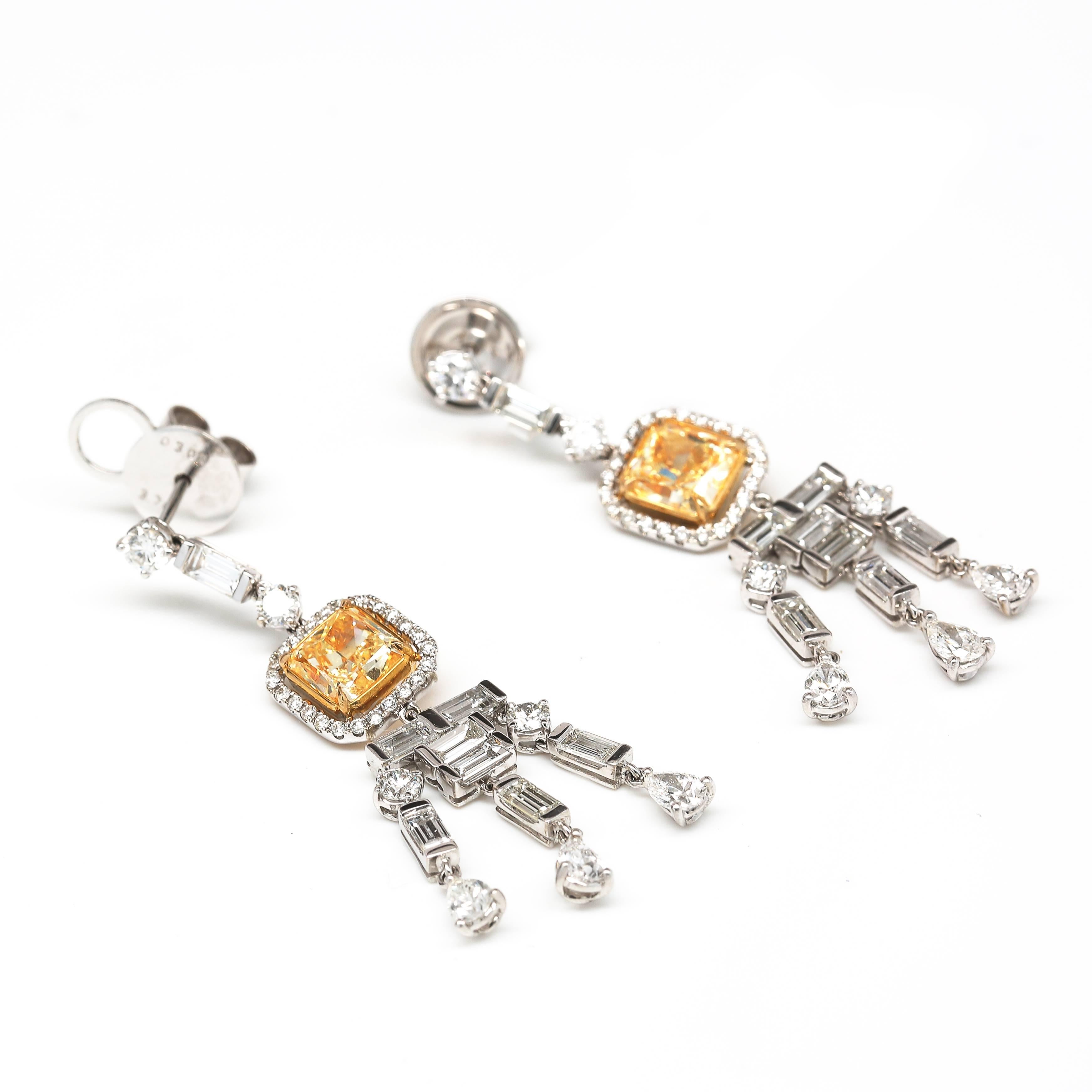 Magnificent Radiant Cut Diamonds weighing 1.59 & 1.58 Carat Fancy Yellow /VVS
These Earrings have 1.93 Carats of Baguettes, .96 Carats of Pear Shapes and 94 Carats in Round Diamonds for a total of 3.83 Carats in D-E VVS Diamonds,  
Total diamond