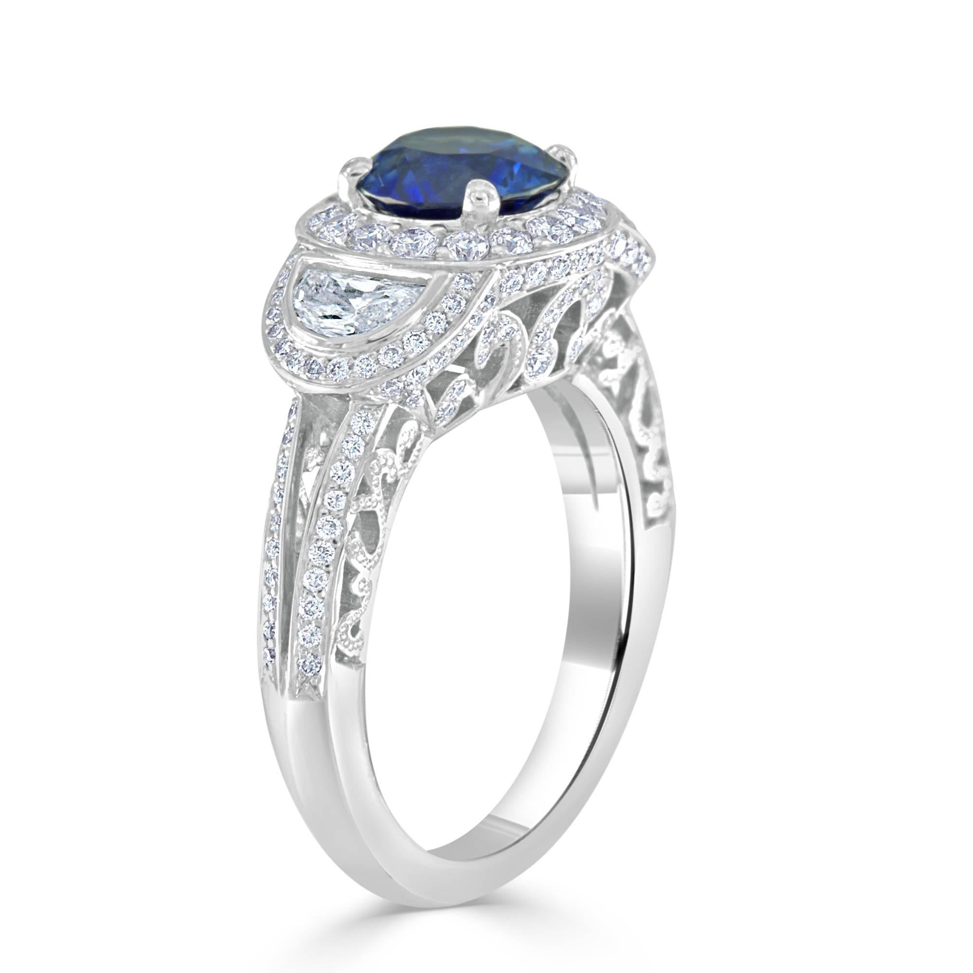 This exquisite sapphire and diamond platinum ring features a 1.74 carat round sapphire having excellent color and cut. Set with 2- half moon cut diamonds weighing 0.51 carat total, having VS clarity and G color. Also set with 148- round brilliant