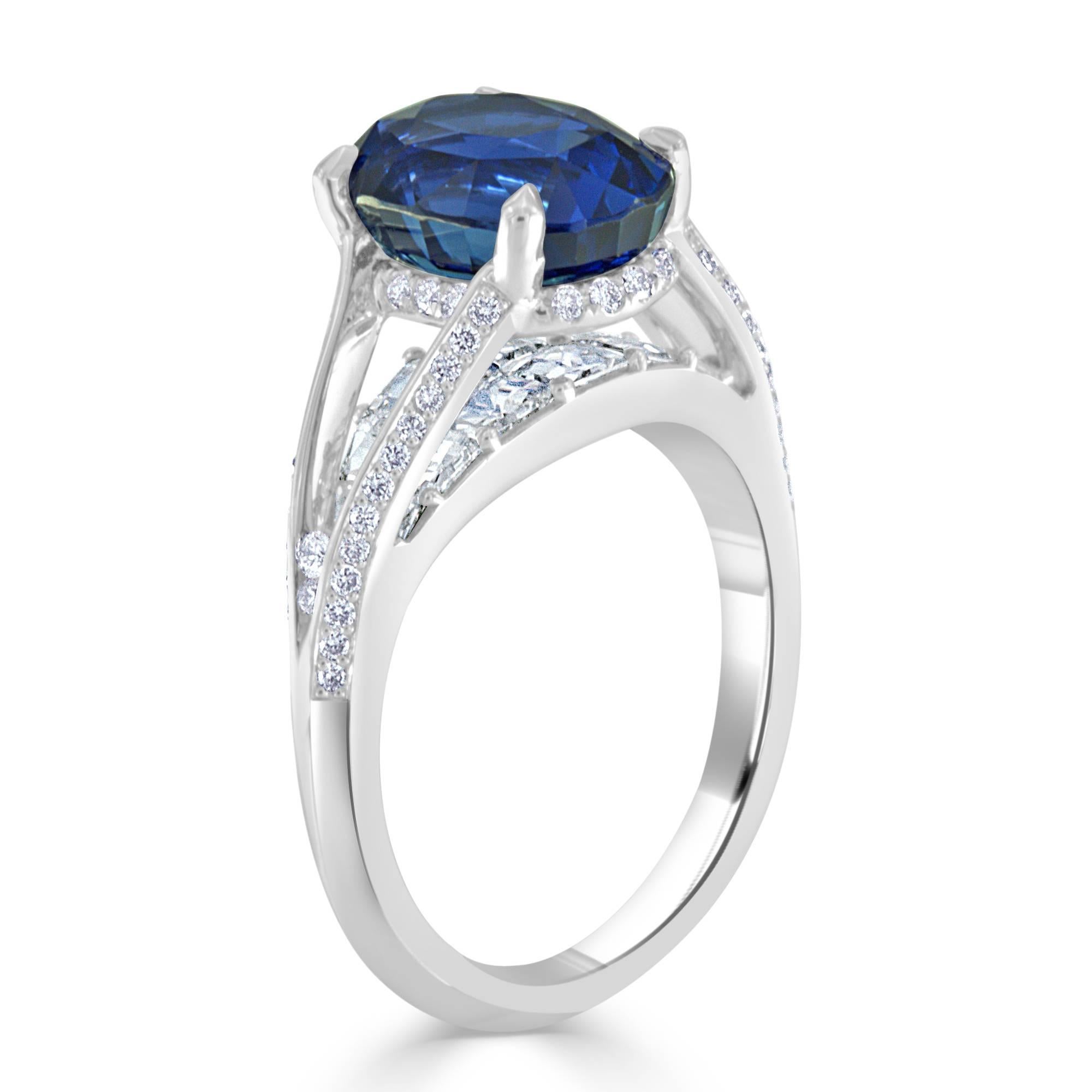 This magnificent sapphire and diamond ring designed by award winning designer and gem cutter Bez Ambar features a 5.16 carat oval cut sapphire having excellent color and cut. The 14- Blaze cut diamonds weighing 1.35 carats total are set beneath the