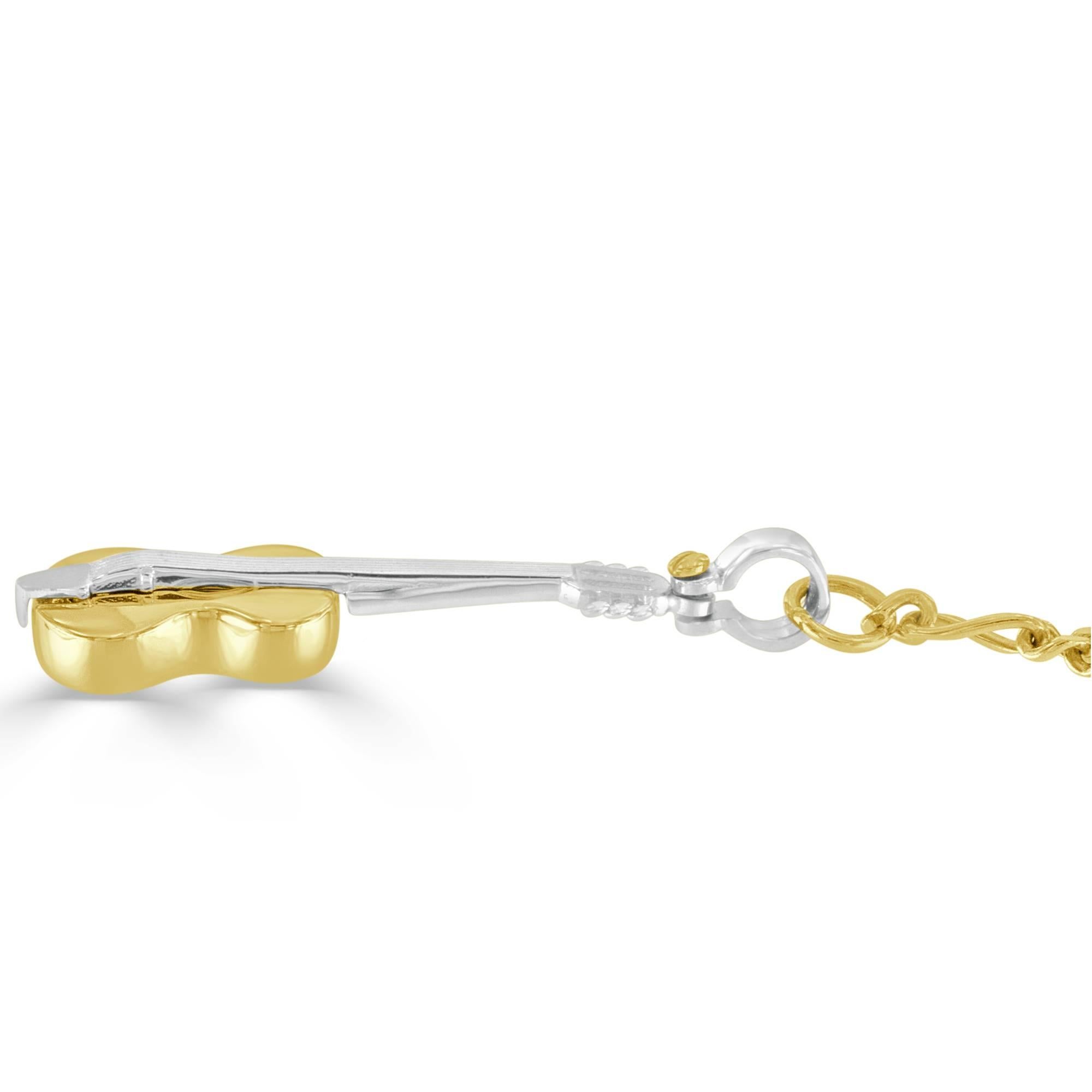 This musical themed key chain is a delight for any symphony patron! The 14 karat white and yellow gold violin measures 1.50 inches in length and 0.50 inch in width, the entirety of the key chain measuring 4.50 inches in length (one inch 14k key
