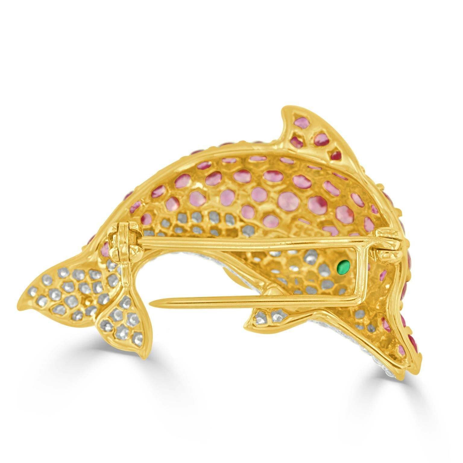 This charming dolphin brooch is set with 45- round cut pink sapphires weighing approximately 3.38 carats total, having excellent color and cut. Set with 101- round brilliant cut diamonds weighing approximately 0.81 carats total, having VS clarity