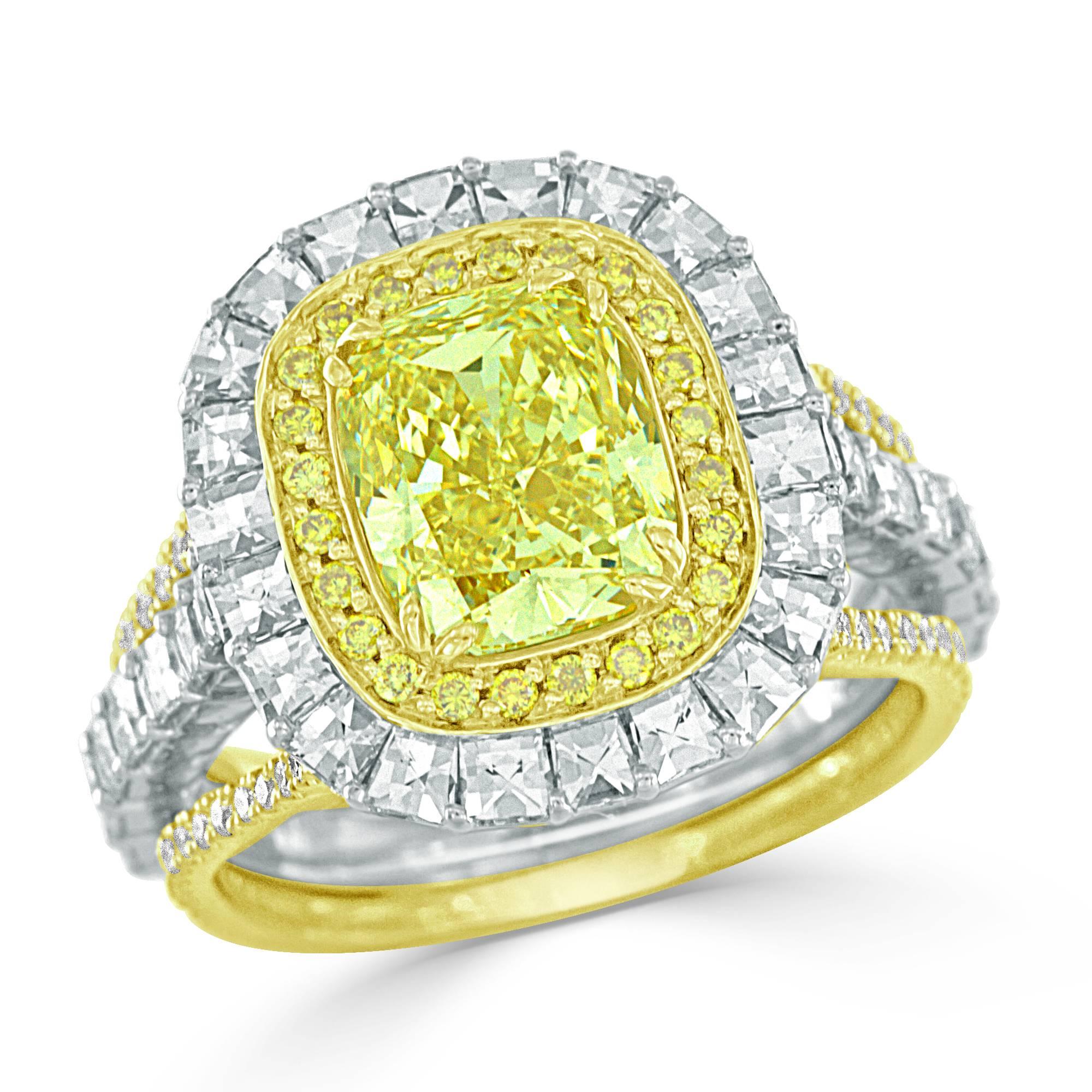 This breathtaking Bez Ambar designer fancy intense yellow diamond ring has a very captivating look. Featuring a GIA certified 2.40 carat fancy intense yellow cushion cut diamond, with a halo of round brilliant cut fancy yellow diamonds. These superb