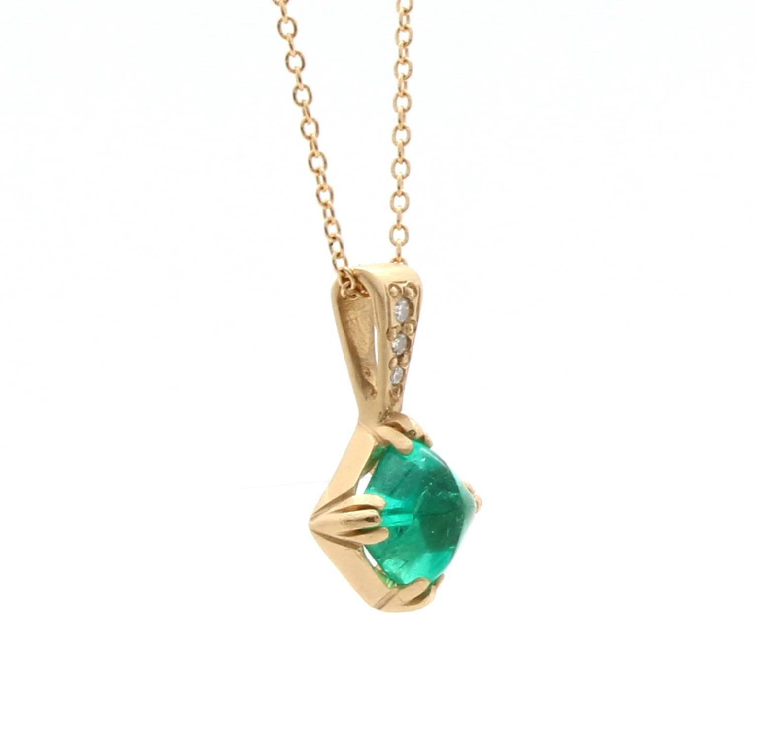 This one-of-a-kind 14k yellow gold pendant features an antique natural 1.37  carat sugarloaf emerald with no indications of heat treatment. It is accented by pave set round brilliant cut diamonds with a total carat weight of 0.033, G-H color and VS