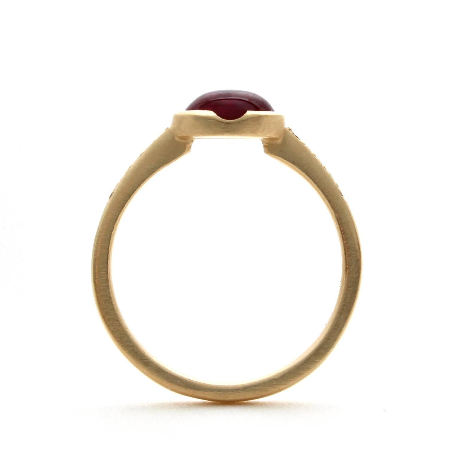 This one-of-a-kind 18k yellow gold ring features an antique natural 1.42 carat cabochon ruby with no indications of heat treatment. It is accented by pave set round brilliant cut diamonds with a total carat weight of 0.09, G-H color and VS clarity.