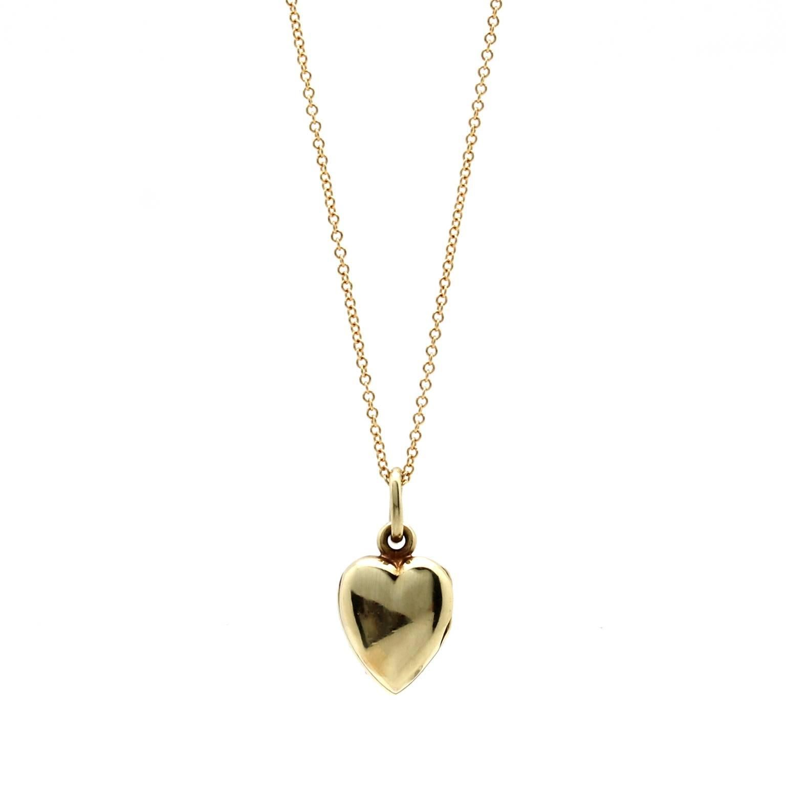 This vintage locket features pave-set freshwater seed pearls on its front and a polished smooth metal back. It is made of 14k yellow gold and hangs from a new 14k yellow gold 18″ chain. The original inside frames of the locket are in excellent