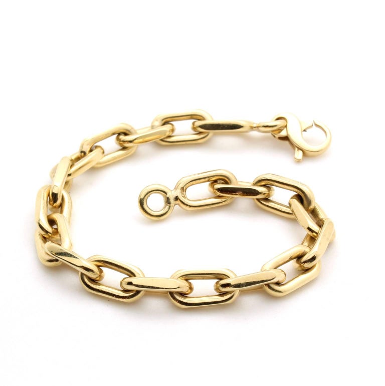 This classic flat-link style chain is made of 18k yellow gold. The bracelet has a great heft as the metal is solid (not hollow). The length of the bracelet is 8" and the links measure 7mm in width. 