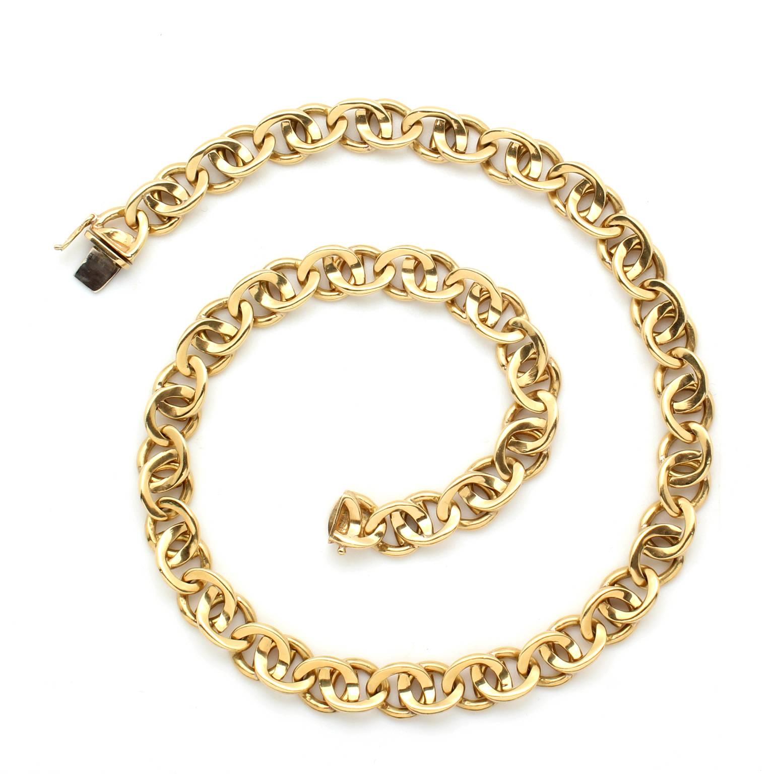 This vintage chain necklace, circa 1980, is made of 18k yellow gold. The necklace has a great heft, the total weight is 3.7 Troy ounces. The links measure 10mm in width. When worn, the necklace is 17.75