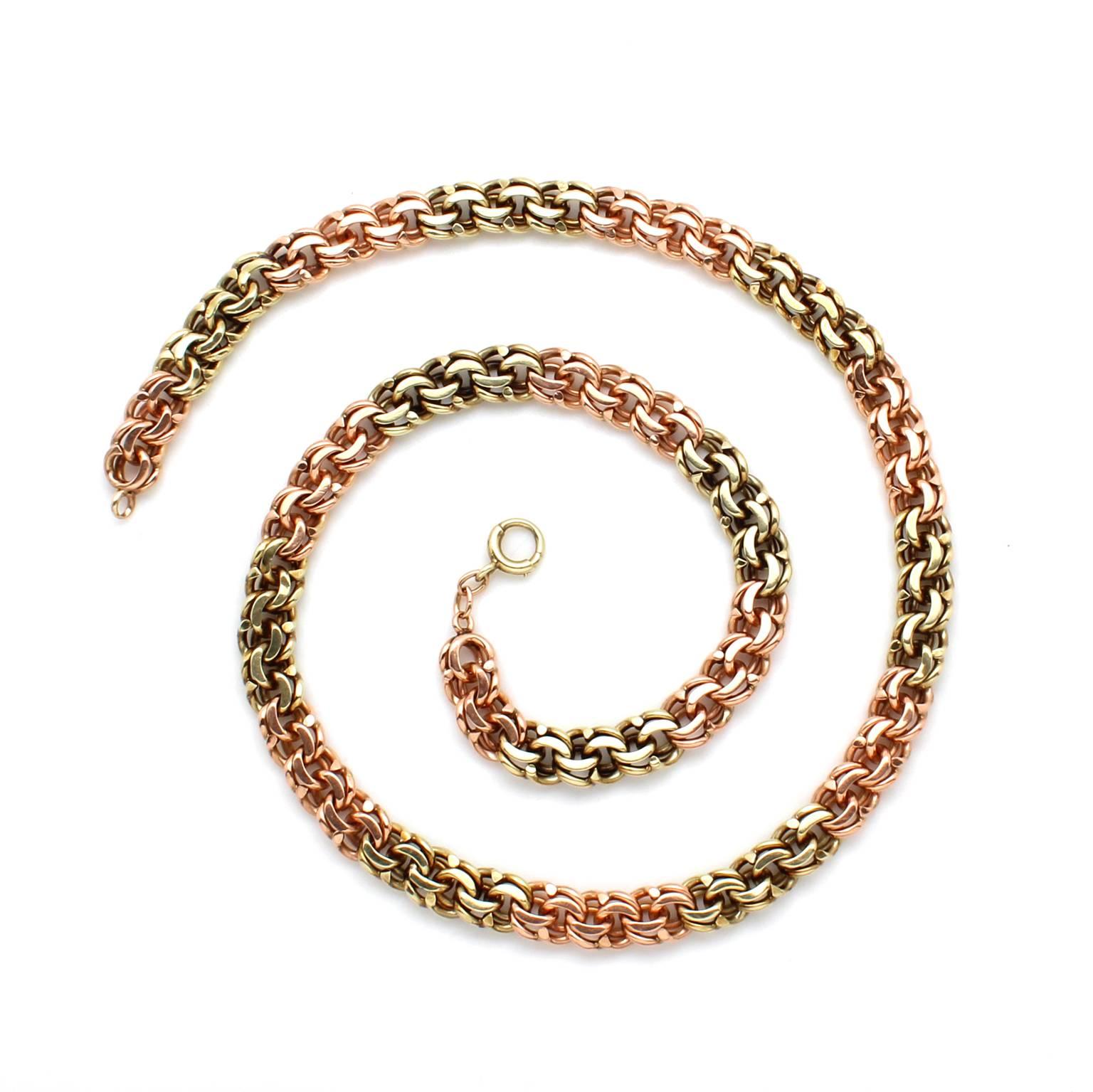 This vintage fancy link chain, circa 1940's, is made of 18k rose gold and 18k green gold in alternating sections. It has a spring ring clasp and great heft. The total weight of the chain is 3.61 Troy ounces. 

When worn, the chain measures 22.5