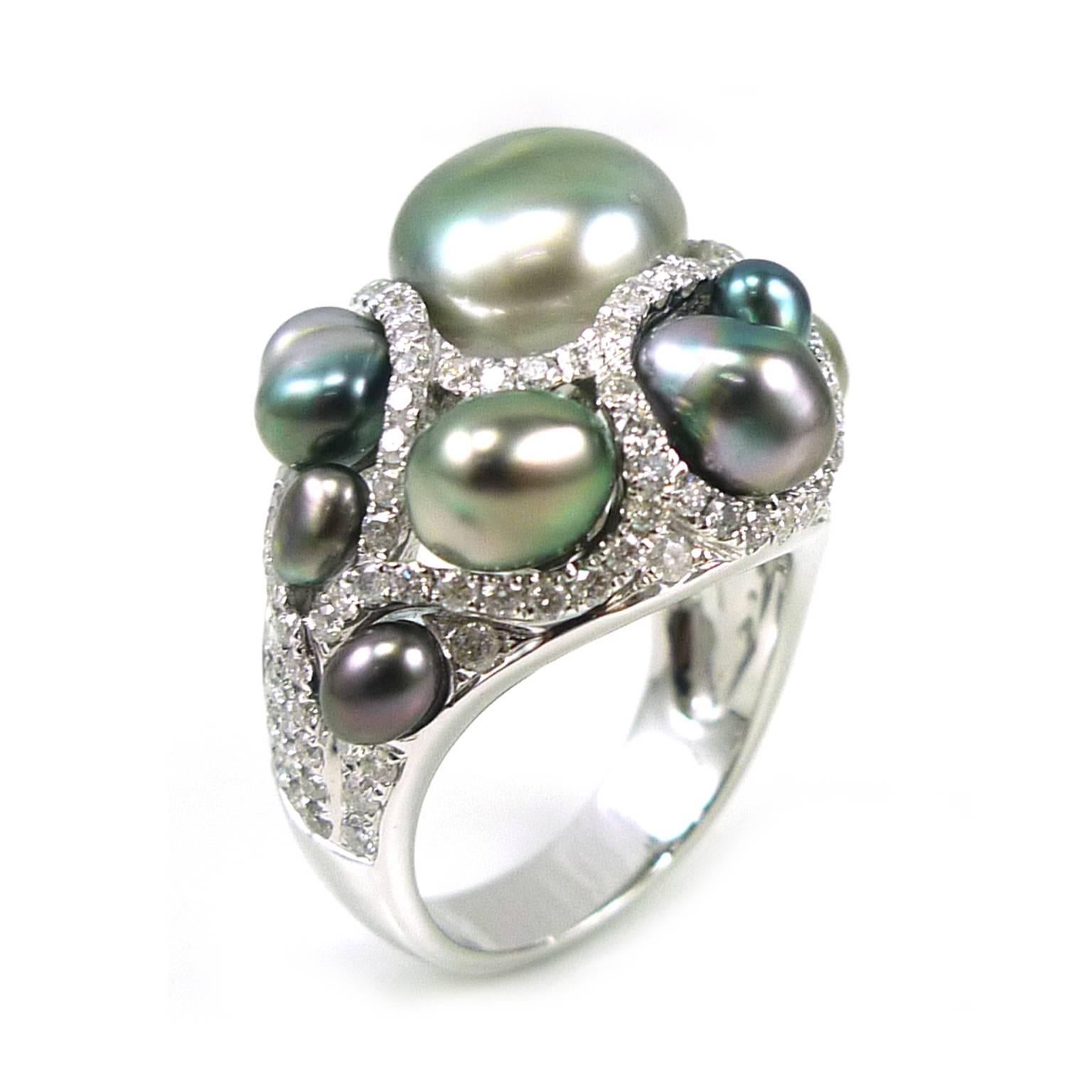 This ring is for those pearl collectors out there that are looking for something unique and different!  There are 9 grey pearls clustered on top with what looks like a river of white diamonds flowing in between each pearl.  This is a size 7, please