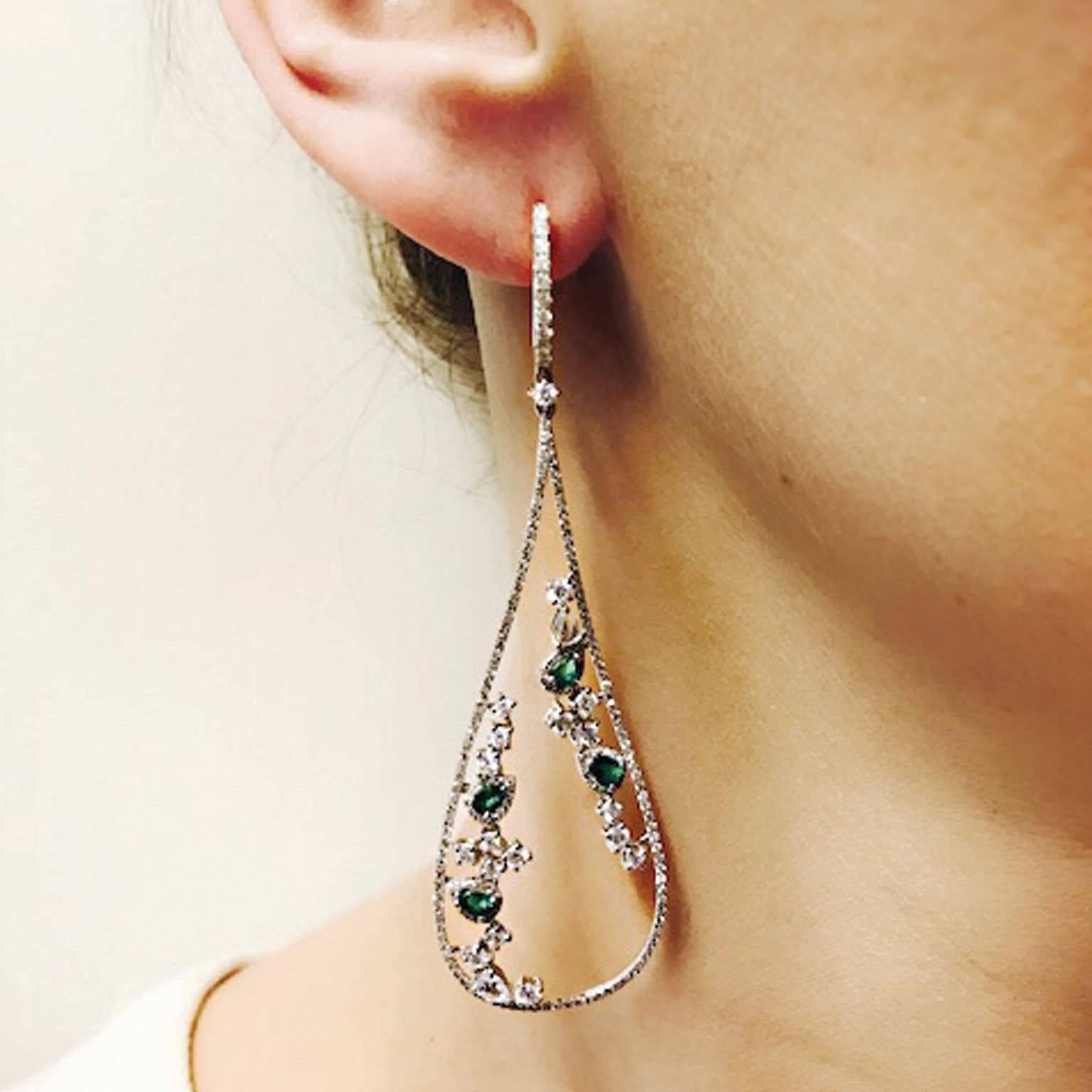 This delicate Emerald and Diamond loop earring contains approx .80ct of Emeralds and approx. 3ct of Diamonds.  Lever back earring. 

79mm in Length