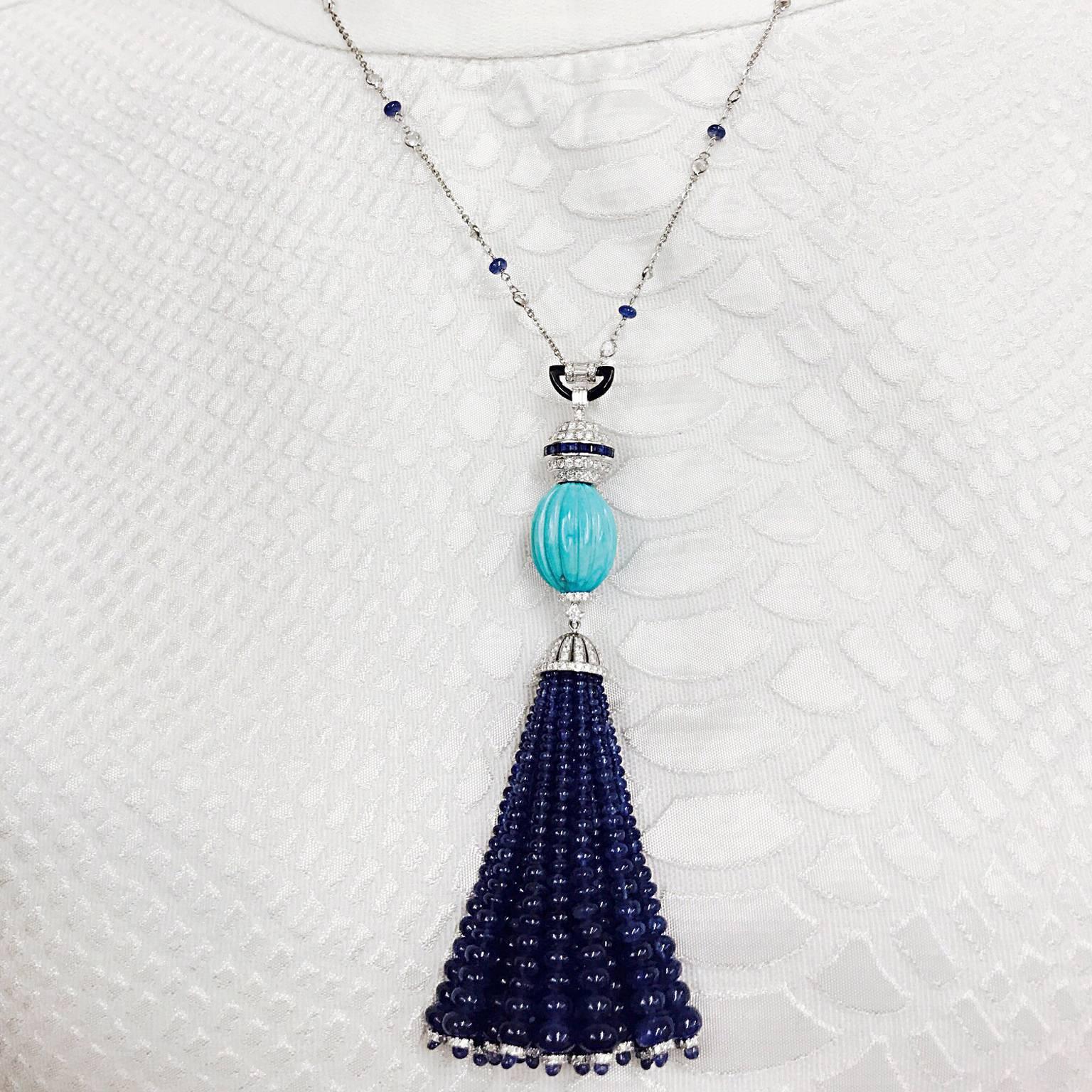 Carved Turquoise with Blue Sapphire Bead Tassel pendant at approx. 4'' in length is attached to a beautiful 18'' Diamond and Blue Sapphire White Gold Chain.

Blue Sapphire - Approx. 7.13cts
Blue Sapphire Beads - Approx. 133.85
Diamond - Approx.