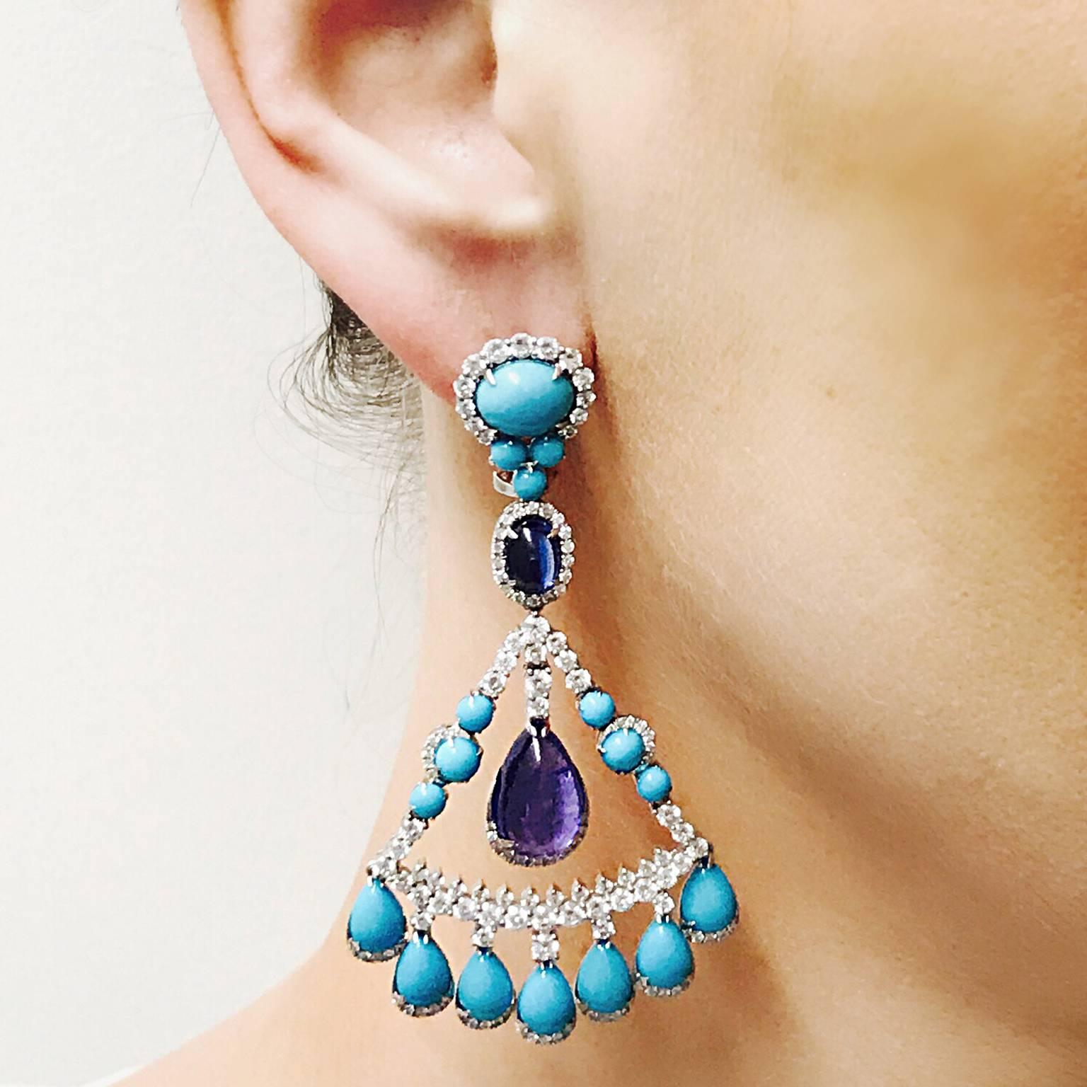 This fun and flirty Natural Turquoise earring is a great addition to any spring or summer outfit!  The Tanzanite Pear Shape drops are approx. 9.46ct with Kyanite ovals that are approx. 2.11ct.  
Diamond - Approx. 4.38ct

65mm in length
Omega Clip /