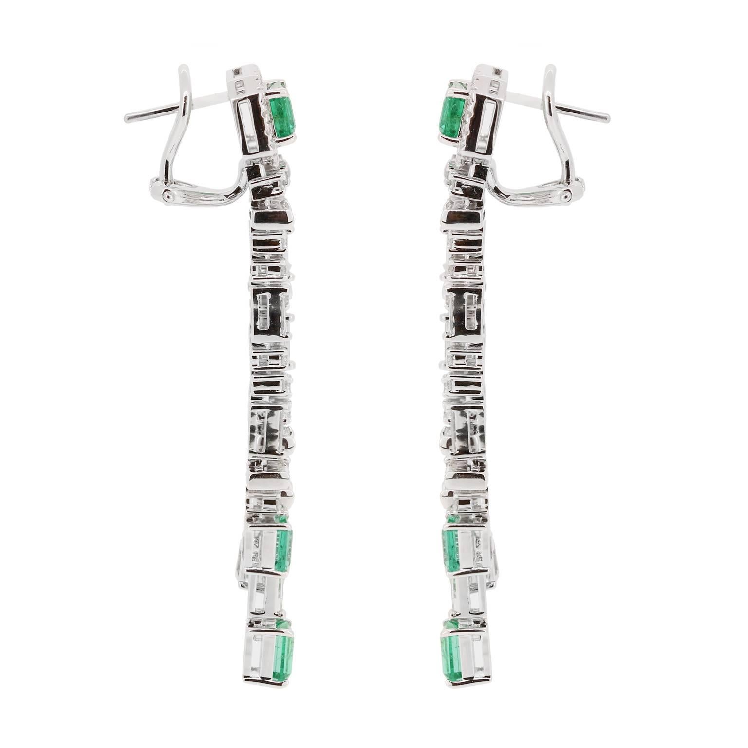 This art deco chandelier earring will make you feel like you have travelled in time back to the Great Gatsby.  Two emerald cut Emeralds at a total carat weight of 2.10 are surrounded by Diamond Baguette 1.43 carats and Diamond Pave 1.42cts to create