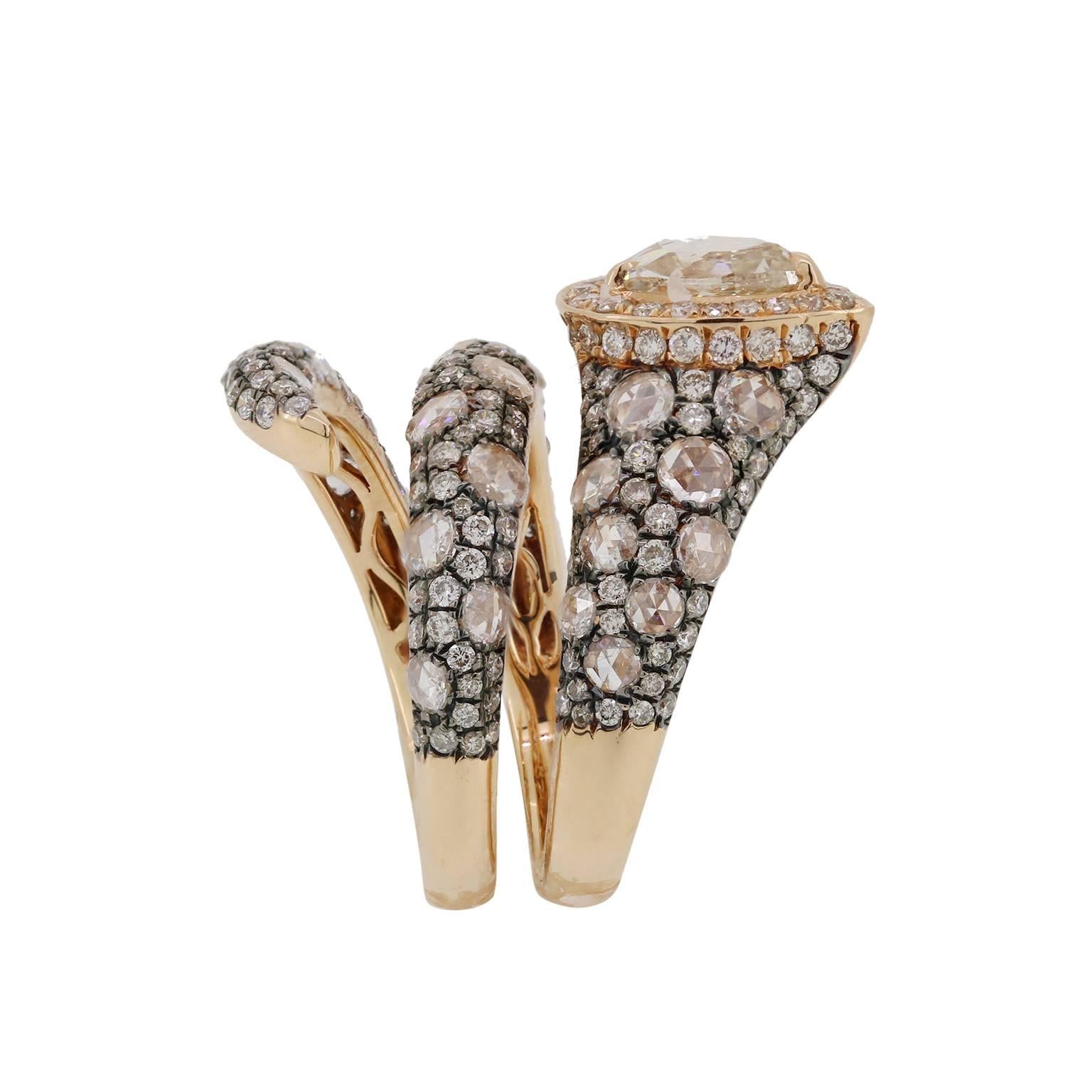 This 0.85-carat pear shape light brown diamond set in 18k yellow gold has a unique wrap design. Rose-cut and full cut diamonds wrap around the band with black rhodium plating to bring out the brilliance of the diamonds.

Size 7, please contact if