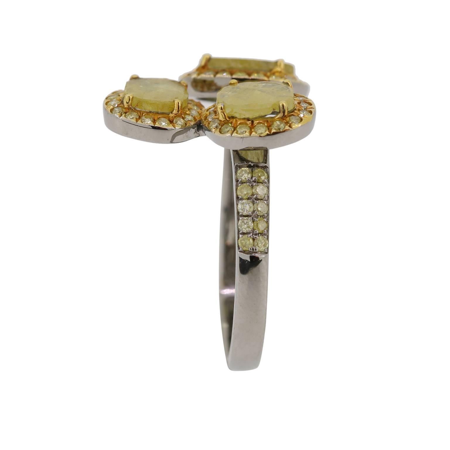 Triple the fun with this open band 3 sliced yellow diamond ring with yellow diamonds halos around each slice.  The yellow diamond pave continues mid way down the ring shank.

Size 7, Please contact if sizing is necessary