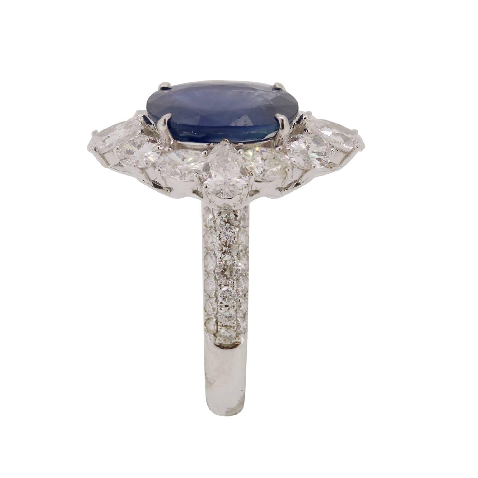 This exquisite 4.25 carat oval Blue Sapphire is surrounded by 0.84 carats of pear and 1.50 carats of oval cut diamonds.  White Diamond pave is then followed down the ring shank to complete this regal ring. 

Size 7, please contact if sizing is