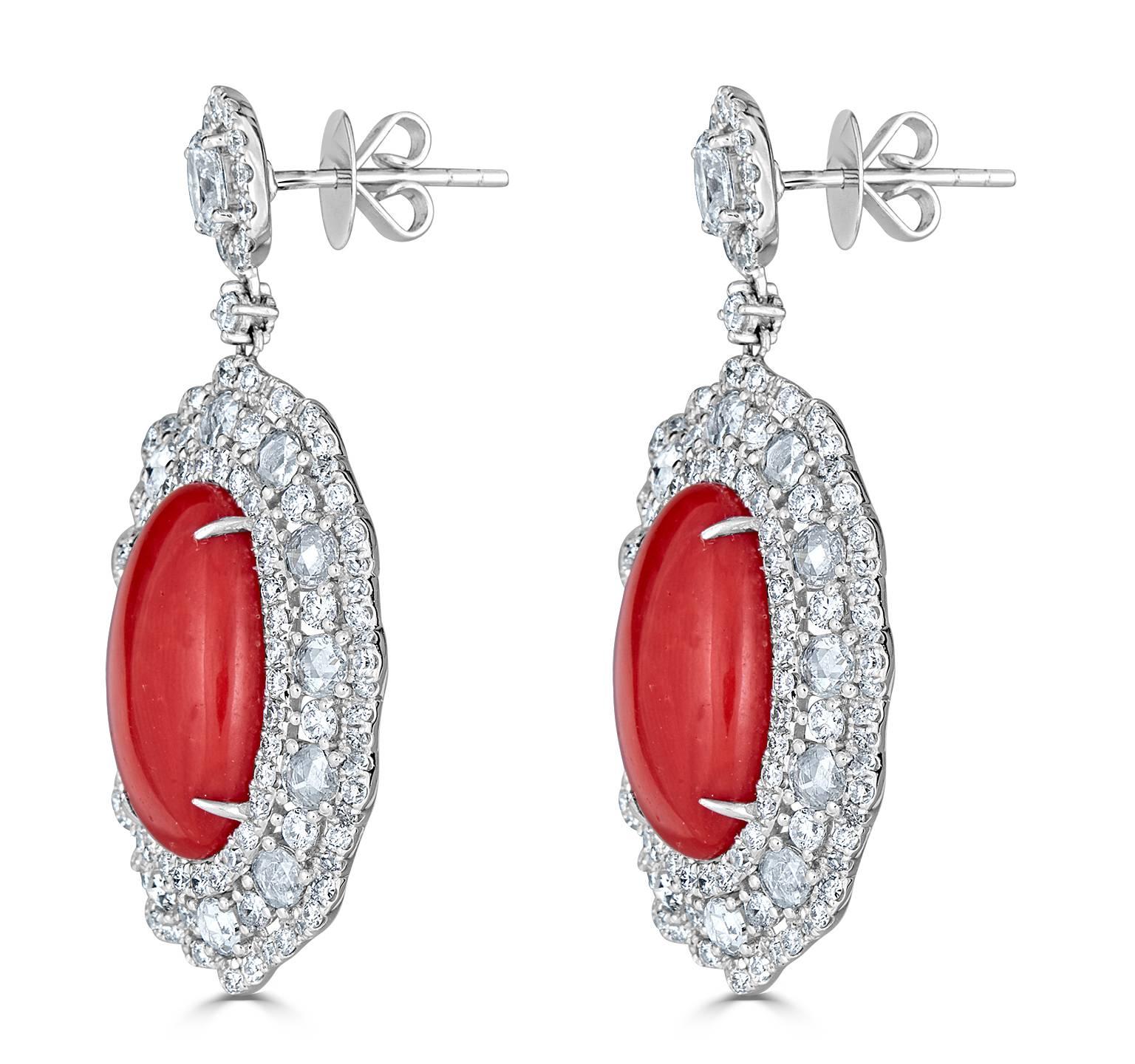 Smart and fashionable.  The rich color of this natural red coral is out of this world!  The white diamond setting complements perfectly with the natural red coral.  Post / Clutch Back

Diamond approx. - 5.60tcw
Red Coral approx. - 12.90tcw
Length -
