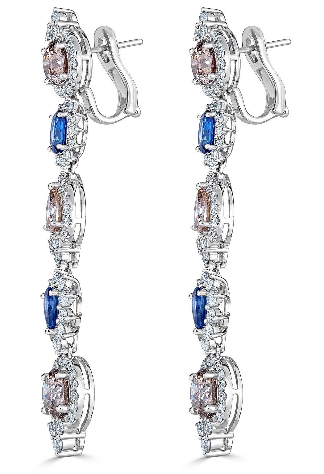 Linear earrings are the biggest trend this season.  This sleek and chic earring has 6 solitaire brown diamonds alternating 4 blue sapphires with a shimmering white diamond halo around each stone.  Post / Omega Clip

Brown Diamond approx. -