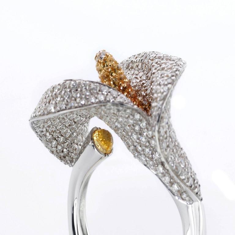 Cocktail Diamond Sapphire 18K Gold Calla Flower Ring Made in Italy
This unique and wonderful ring has been inspired by flowers and its head is a real calla for its volumes. It's surface is covered by many diamonds in order to give it its shape. The