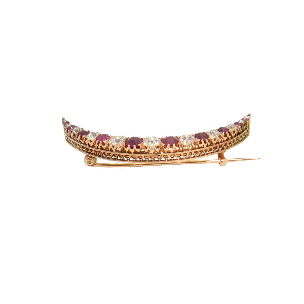 The half moon ruby, diamond and rose gold brooch with antique cut diamonds with a total weight of circa 2.50 carats and rubies with a total weight of circa 3.00 carats. Length circa 5.5 cm and width circa 0.7 cm. Gold weight 9 g. Splendid handcraft