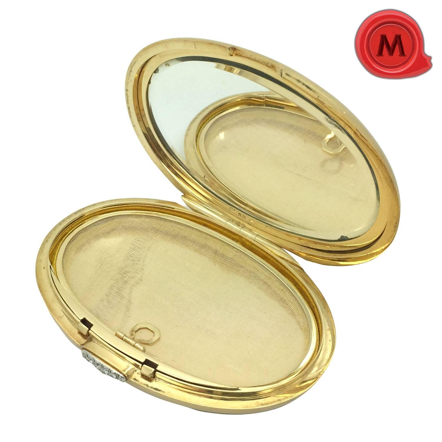 Italian powder box in yellow gold 18K. Firmed Faraone, Milano. Oval. The cover set with marquise and drop cut diamonds, sapphires and rubies. The cover with an interior mirror and the closer set with diamonds. 8.5 cm x 6 cm. Total weight (with the