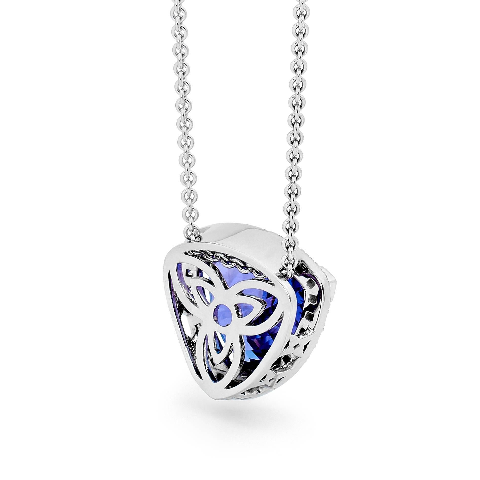 A classic beauty, our Trilliant Tanzanite and Diamonds Pendant showcases a rare, deep coloured 6.86ct Trilliant Cut Tanzanite, set in 18ct White Gold and delicately encased with a Halo of Fine White Diamonds (totaling 0.39CT H/SI). The pendant sits