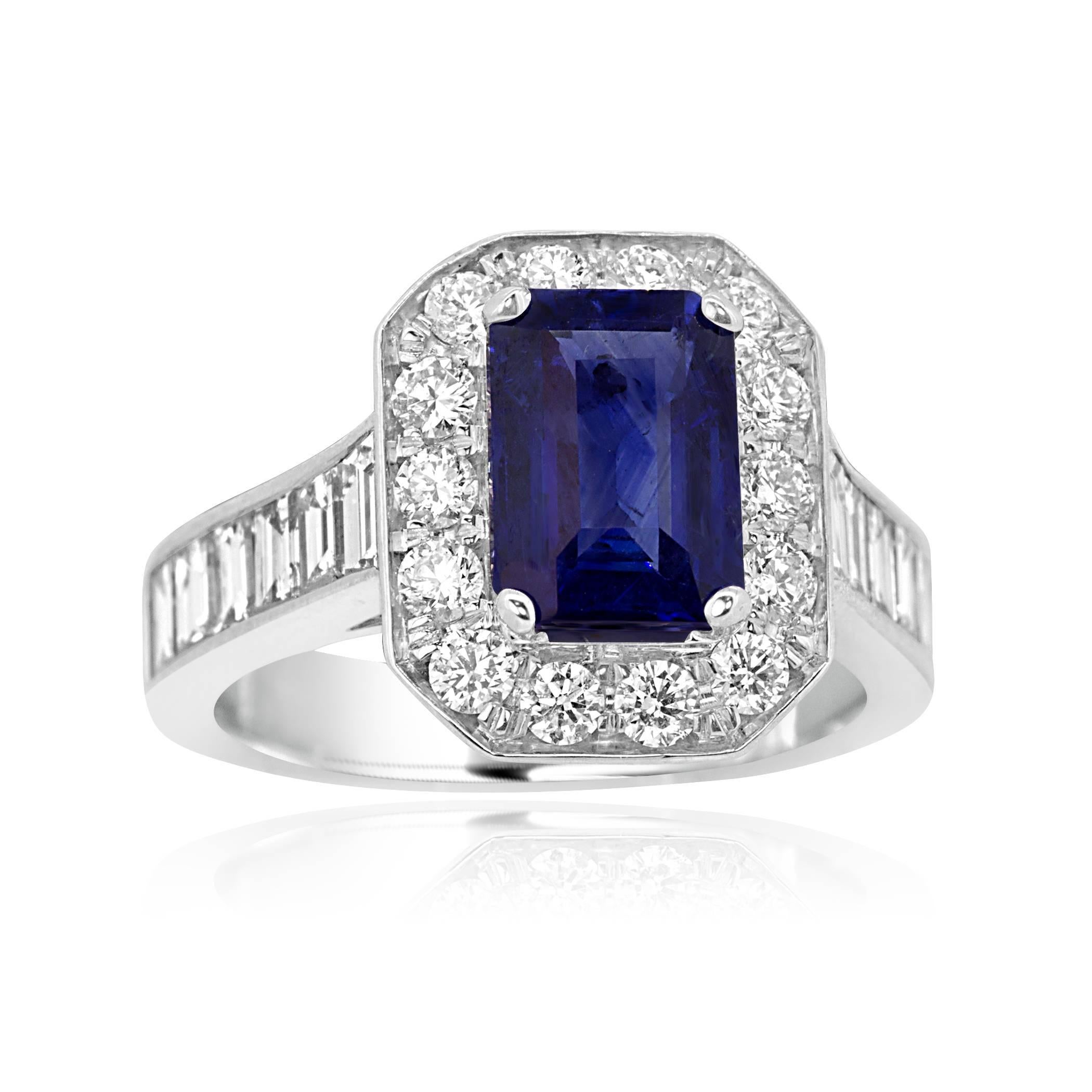 Heated Emerald Cut Blue Sapphire 2.53 encircled in a halo of white diamond 0.57 Carat Flanked by baguette shape white Diamonds on the shank 1.31 Carat in 18K white gold. 
MADE IN USA.

Blue Sapphire 2.53 Carat
Diamond total weight 1.88 Carat