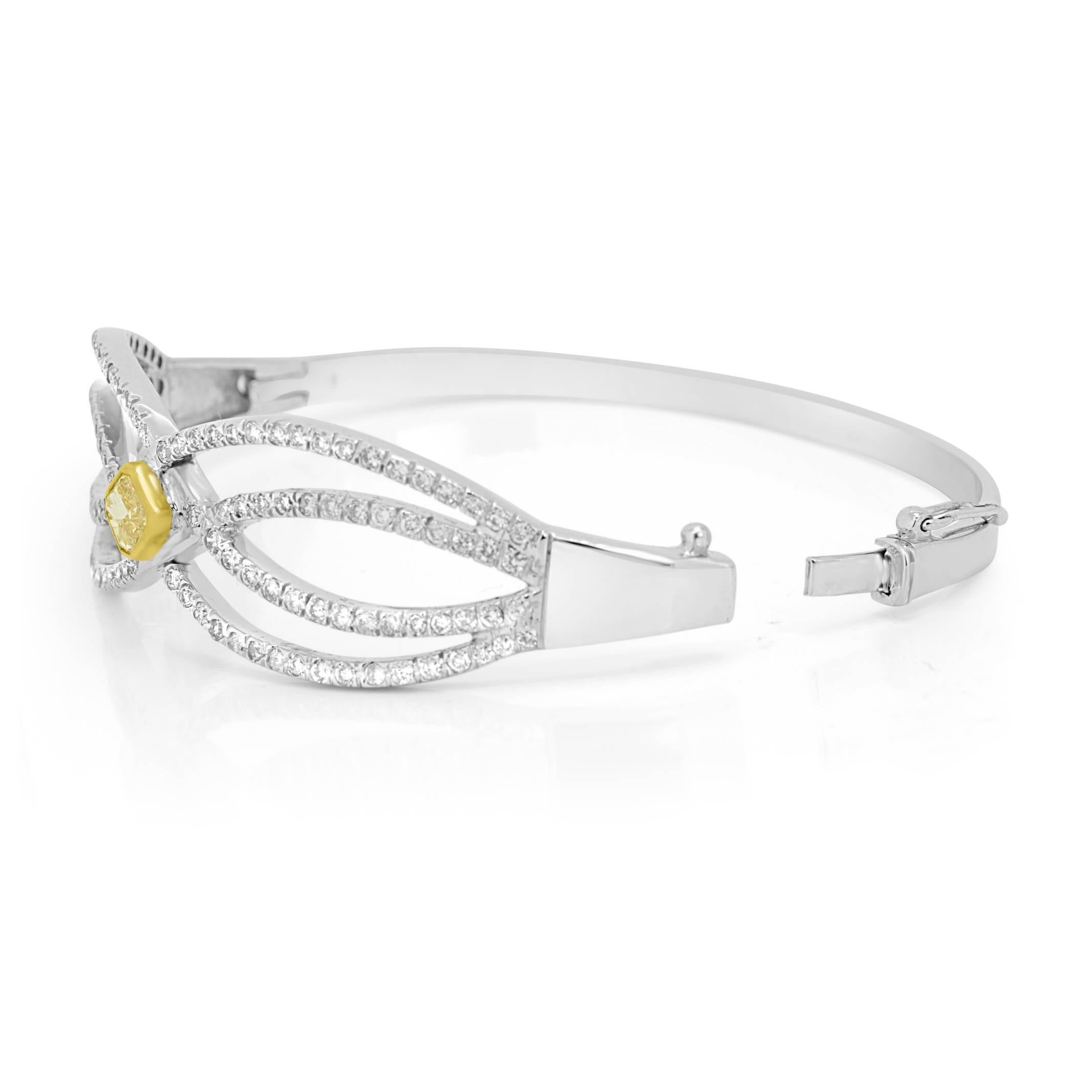 Natural Fancy Yellow Radiant 0.71 Carat and White Diamond 1.50 Carat in 14k white and yellow gold Bangle bracelet.
