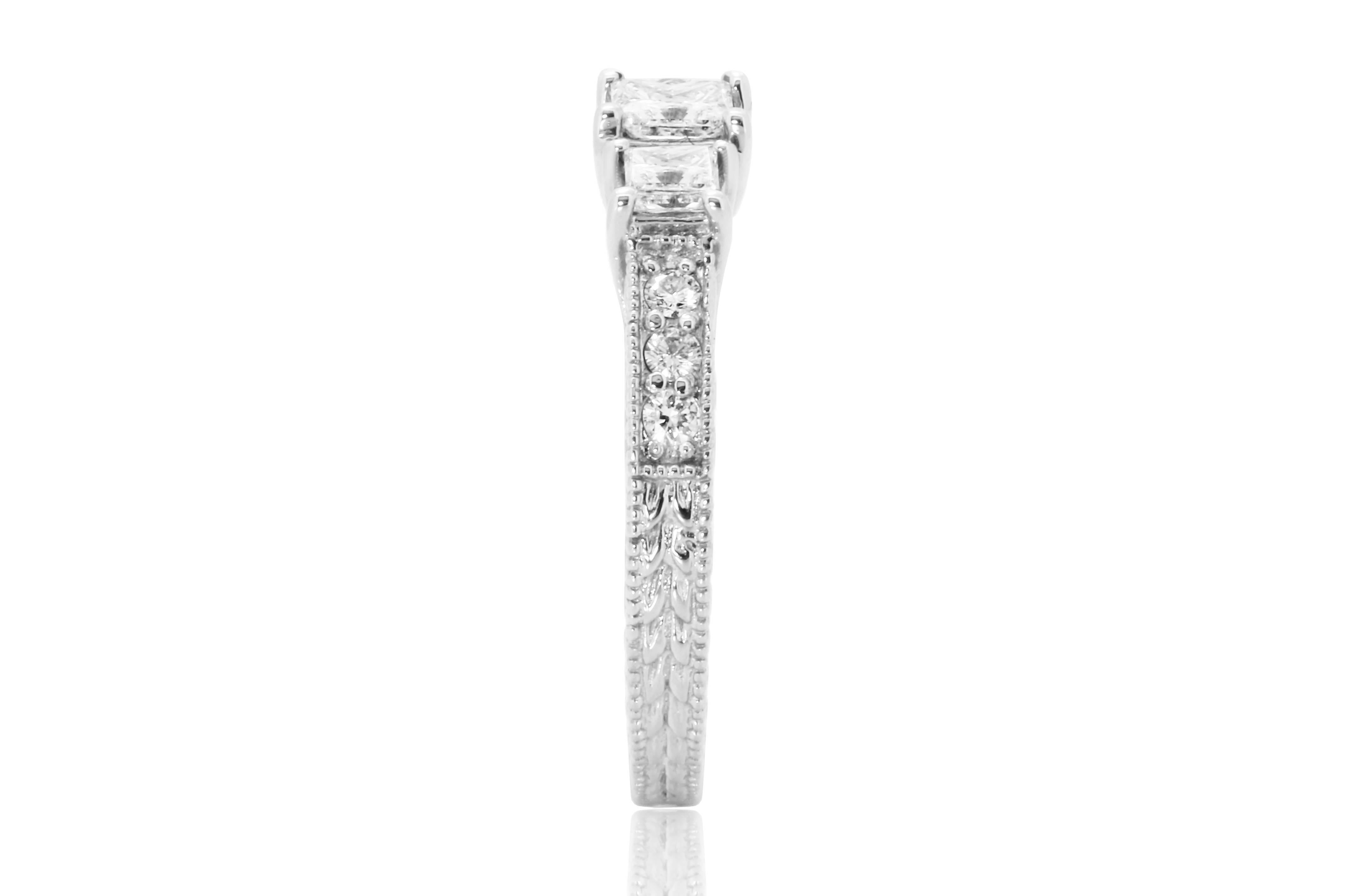 Very Beautiful Three Stone Princess Cut White Diamond 0.63 Carat flanked with 6 white diamond round 0.12 Carat in 14k White Gold Ring with Milgrain and carving.

MADE IN USA
Total Diamond Weight 0.75 Carat