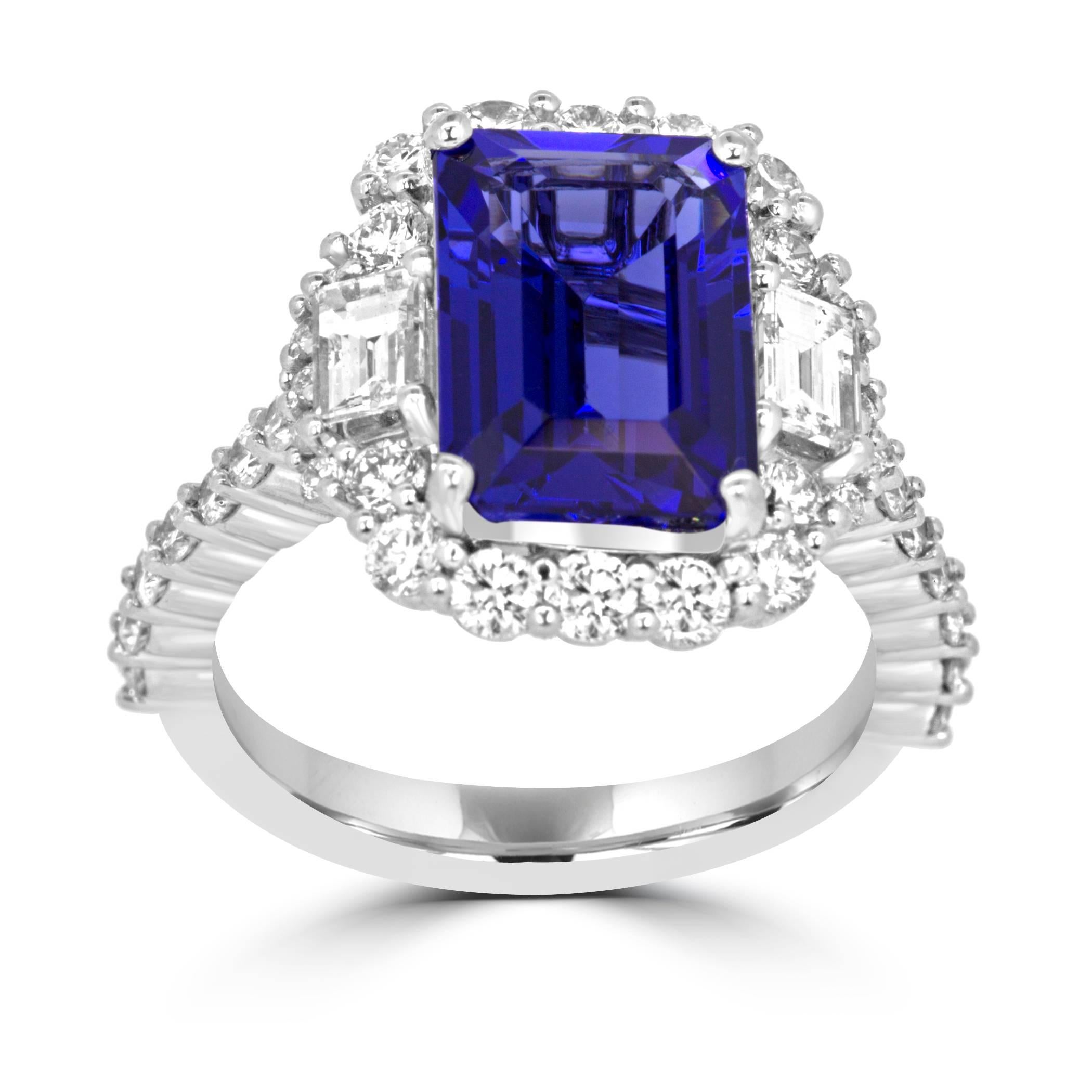 Gorgeous Emerald cut Tanzanite 3.98 Carat encircled in a halo of White Round Diamonds 1.05 Carat Flanked by 2 Diamond Trapezoid 0.43 Carat in 14K White Gold Ring.

Style available in different price ranges. Prices are based on your selection of 4C's