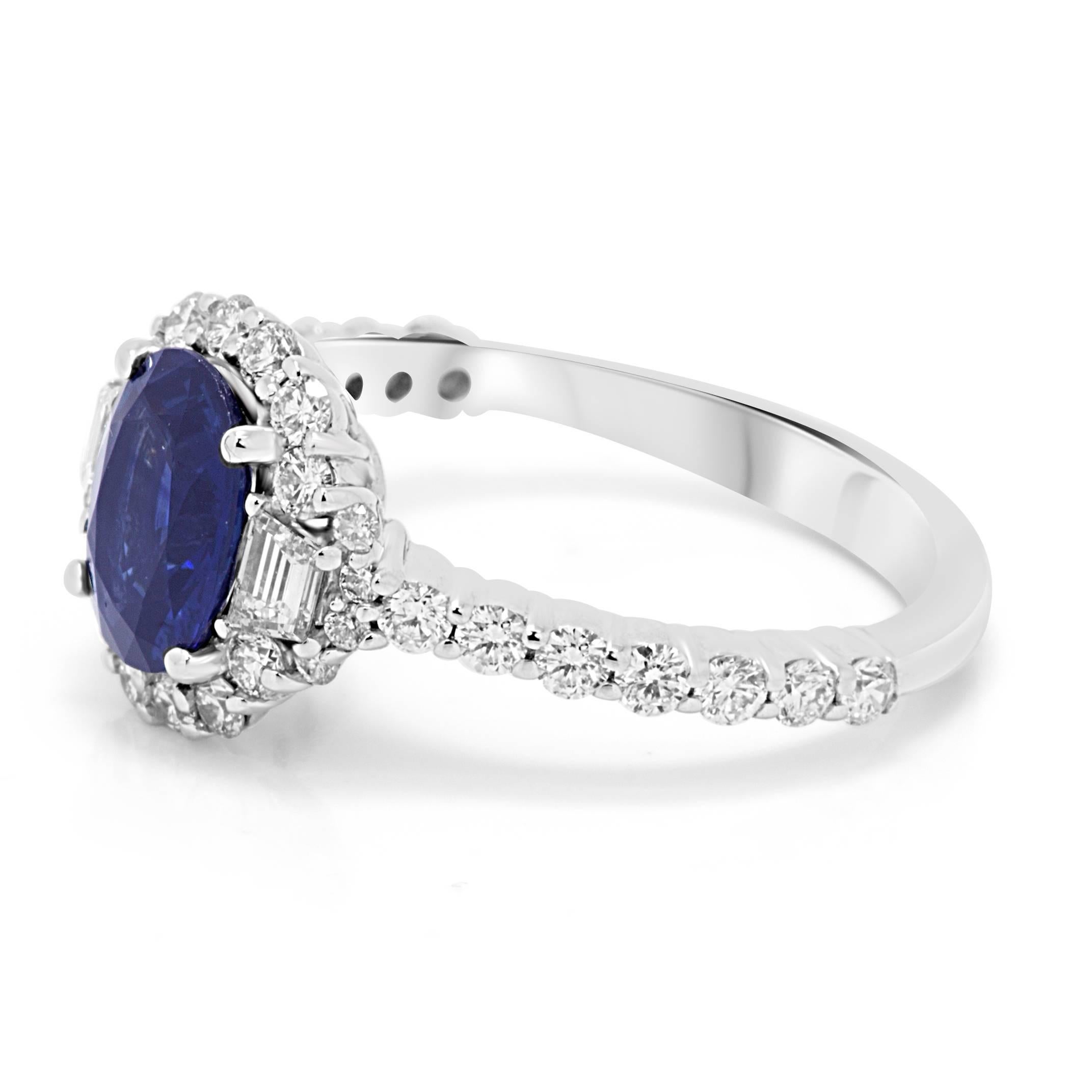Blue Sapphire Oval 1.46 Carat encircled in a Halo of white Round Diamonds 0.61 Carat Flanked by 2 Diamond Trapezoids on the side 0.18 Carat in a gorgeous 18K White Gold Three stone Bridal Fashion Ring.

Style available in different price ranges.
