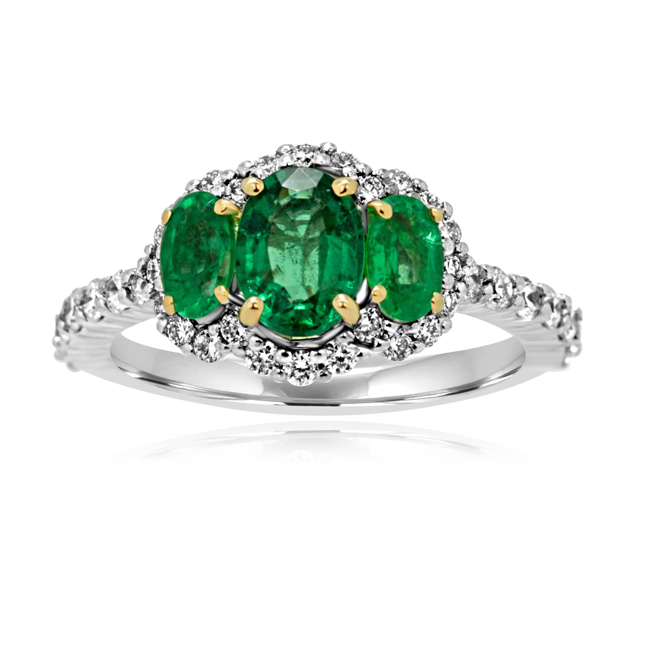 Emerald Oval 0.67 Carat Flanked by 2 Emerald Ovals 0.47 Carat on the side encircled in a halo of white round diamonds 0.55 Carat in 14K White and Yellow Gold Ring.

Style available in different price ranges. Prices are based on your selection of