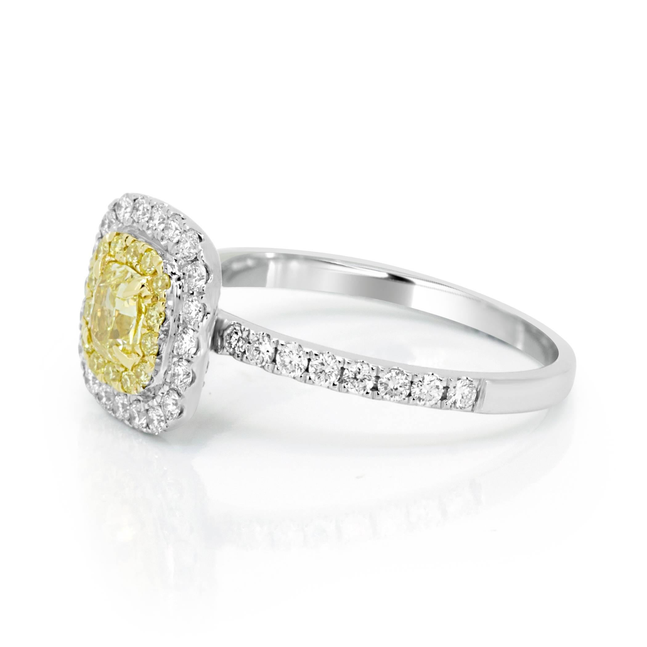 Natural Fancy Yellow Cushion 0.40 carat encircled by one row of Fancy yellow Round Diamond 0.16 Carat and one row of White Diamond 0.41 Carat in 18K White and Yellow Gold Ring with a single row shank Engagement Bridal Fashion Cocktail Ring.

Style