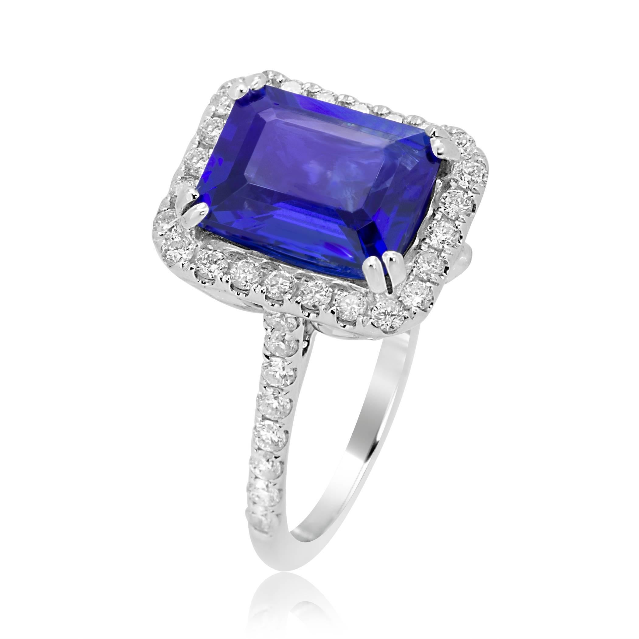 3.56 Carat Emerald Cut Tanzanite in a Halo of White Diamond 44 stones 0.66 Carat in 18K White Gold Ring. With a single row Diamond Shank.