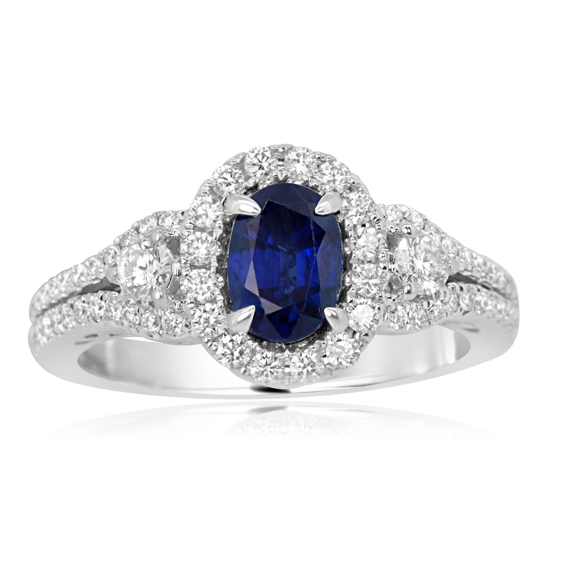 1.00 Carat Blue Sapphire Oval Encircled by Halo of White 0.47  Diamond  Carat Flanked by 2 White Diamond 0.15 Carat in 14K white Gold Two row shank Ring.