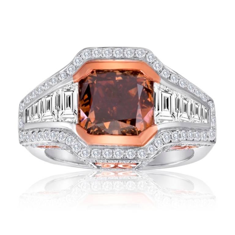 Stunning GIA Certified Fancy Dark Orange and Brown Cushion 4.01 Carat encircled in Halo of white diamond round 1.10 Carat flanked by White Diamond Trapezoids 1.19 Carat in 18K White and Rose Gold one of a kind Handmade Fashion Cocktail ring.

Style