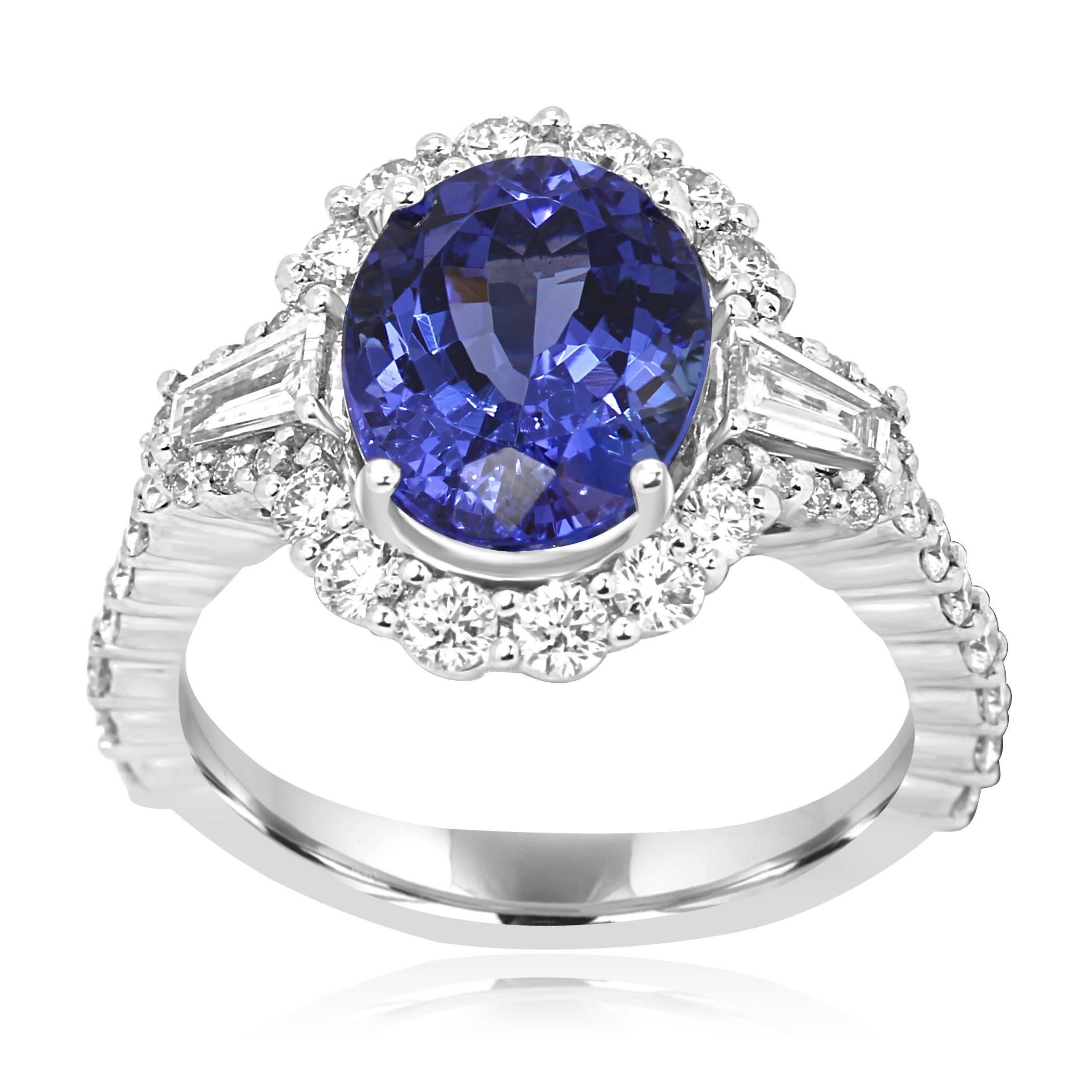 Gorgeous Tanzanite Oval 4.42 Carat encircled in a single Halo of White Round Diamonds 0.87 Carat flanked by 2 White Diamond Tapers on the side 0.31 Carat in 14K White Gold Three Stone Fashion Cocktail Ring.

Style available in different price