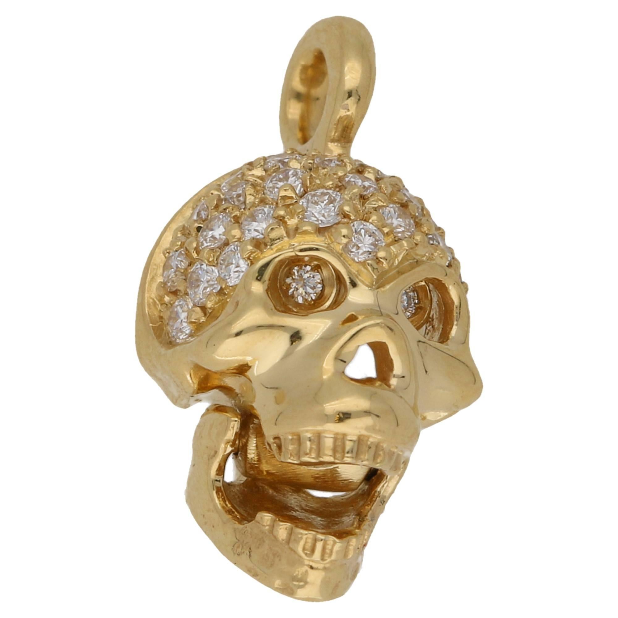A fantastic 18ct yellow gold skull pendant with a pave set diamond skull and a hinged jaw that opens to cause the skull's diamond set eyes to pop out! Diamond weight: 0.28ct G/Vs. The pendant is 15mm in length and 8mm in width.