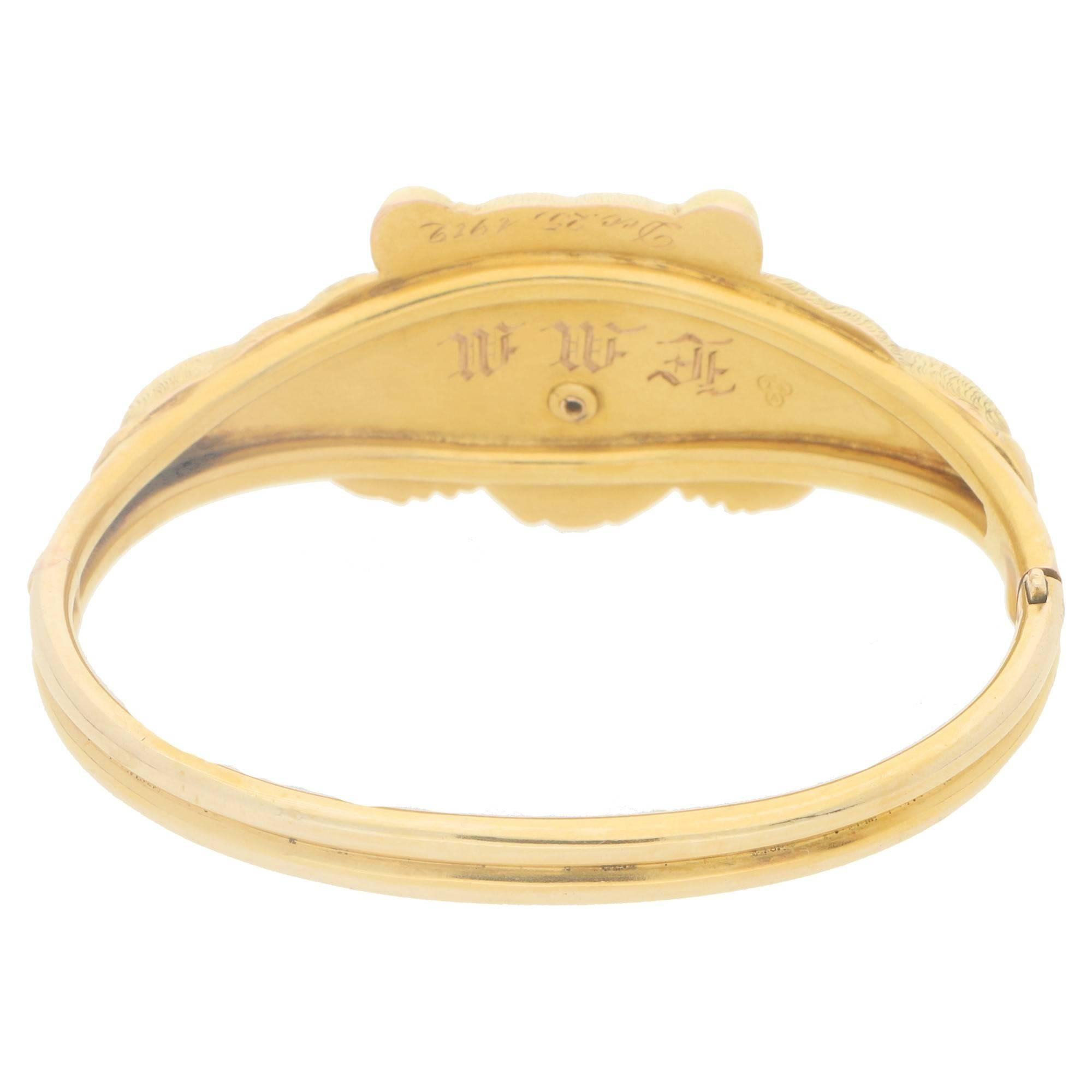 A turn of the century lifelike bear bear bangle. The bangle is formed of a central motif of a bear laying down head on. The hand carved fur detail is further embellished with round brilliant cut diamond eye and mouth detail. The underside of the