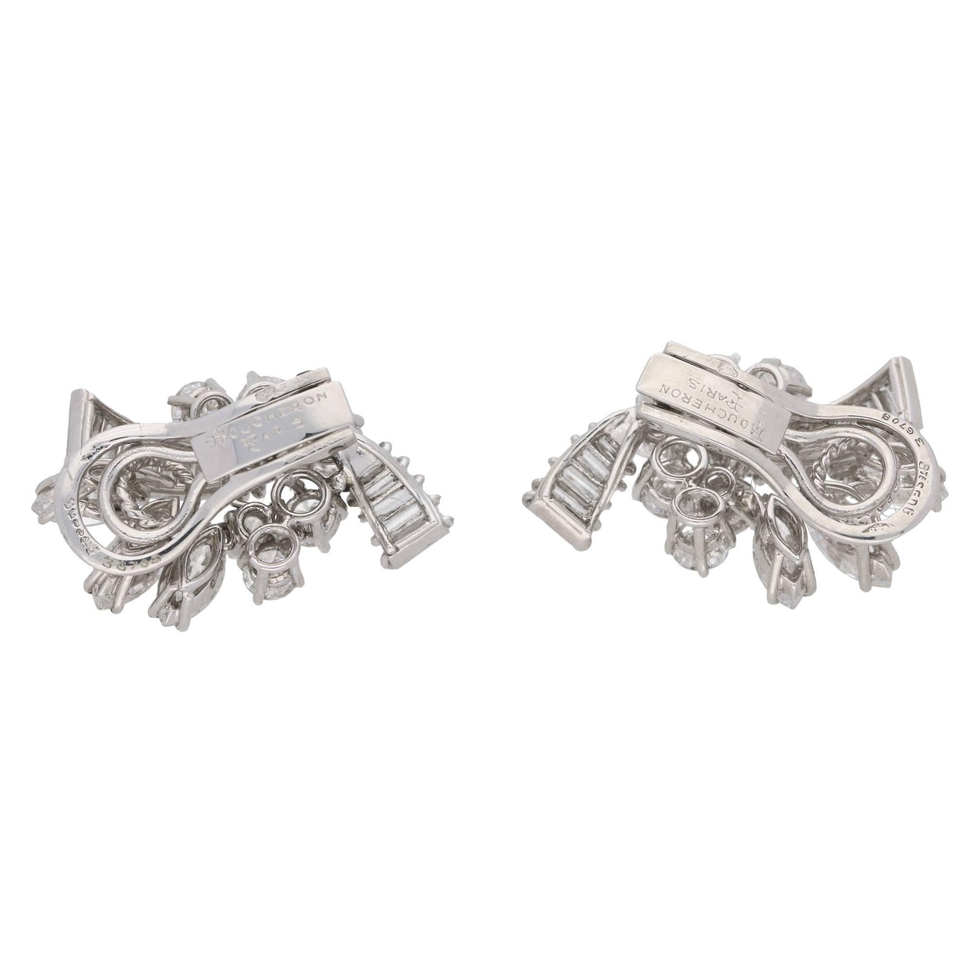 A pair of 1950's platinum and diamond spray ear clips by Boucheron Paris. Each earring comprises of a melody of diamond cuts, round brilliants, marquises and baguette cuts, expertly set into a delicate and lively platinum mount. With three marquise