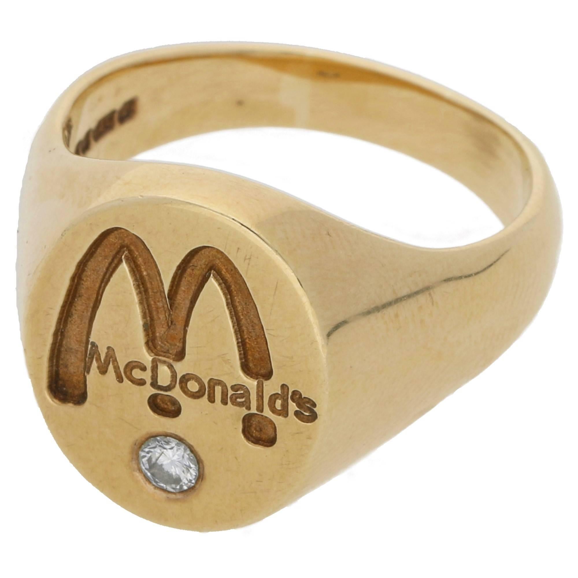A collectible 9ct McDonald's logo signet ring, originally given as a gift to long standing employees. A fun and wearable vintage piece! Set with a round brilliant diamond. This ring can be sized upon request. With full hallmarks: London, 1993, 375